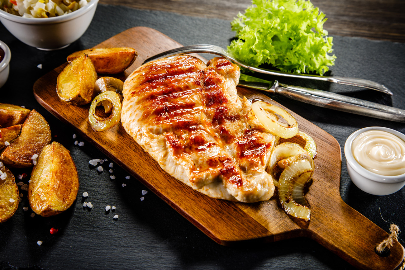 Grilled chicken breast, French fries and vegetables