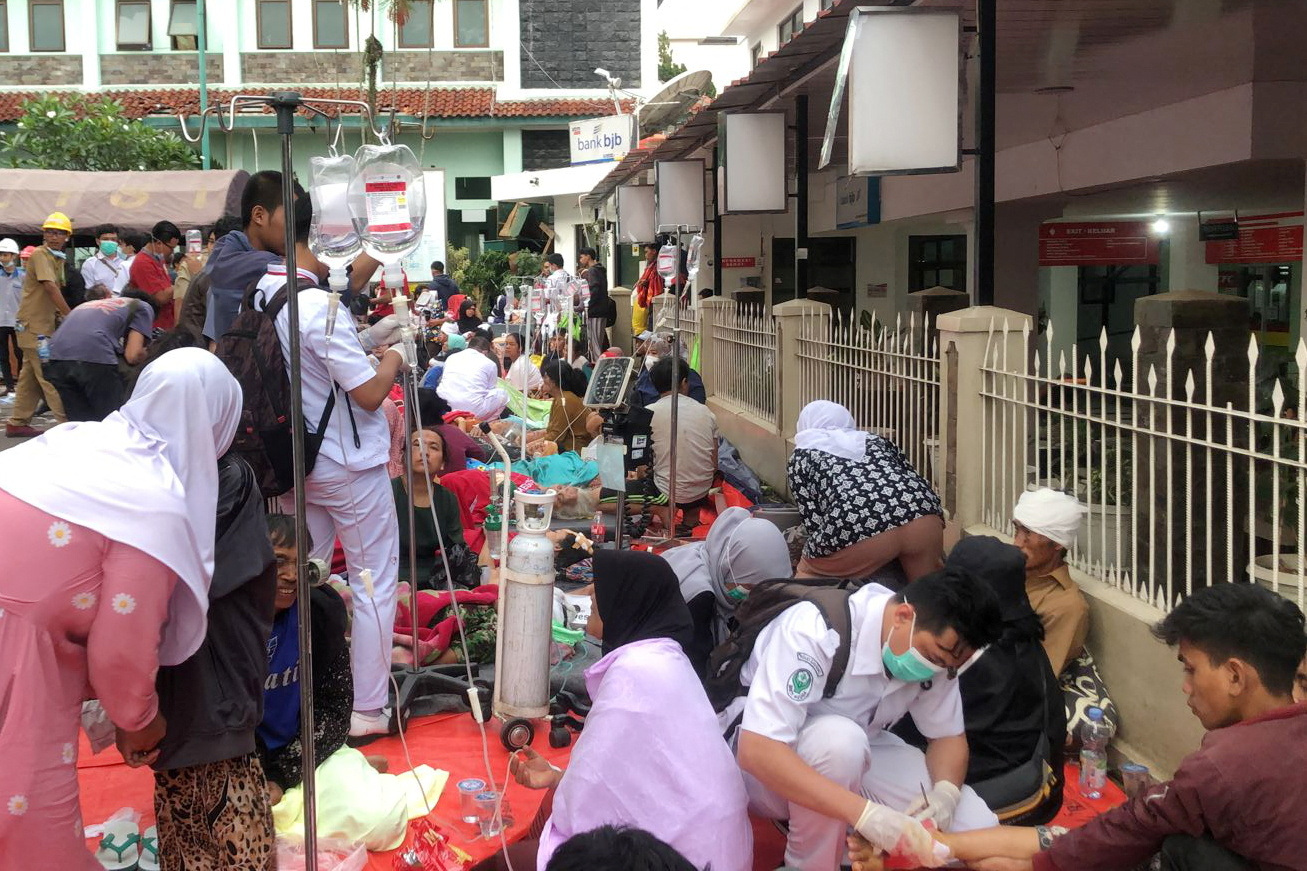 Medical workers treat the victims outside a hospital building after an earthquake hit in Cianjur, West Java province, Indonesia, November 21, 2022, in this photo taken by Antara Foto. Antara Foto