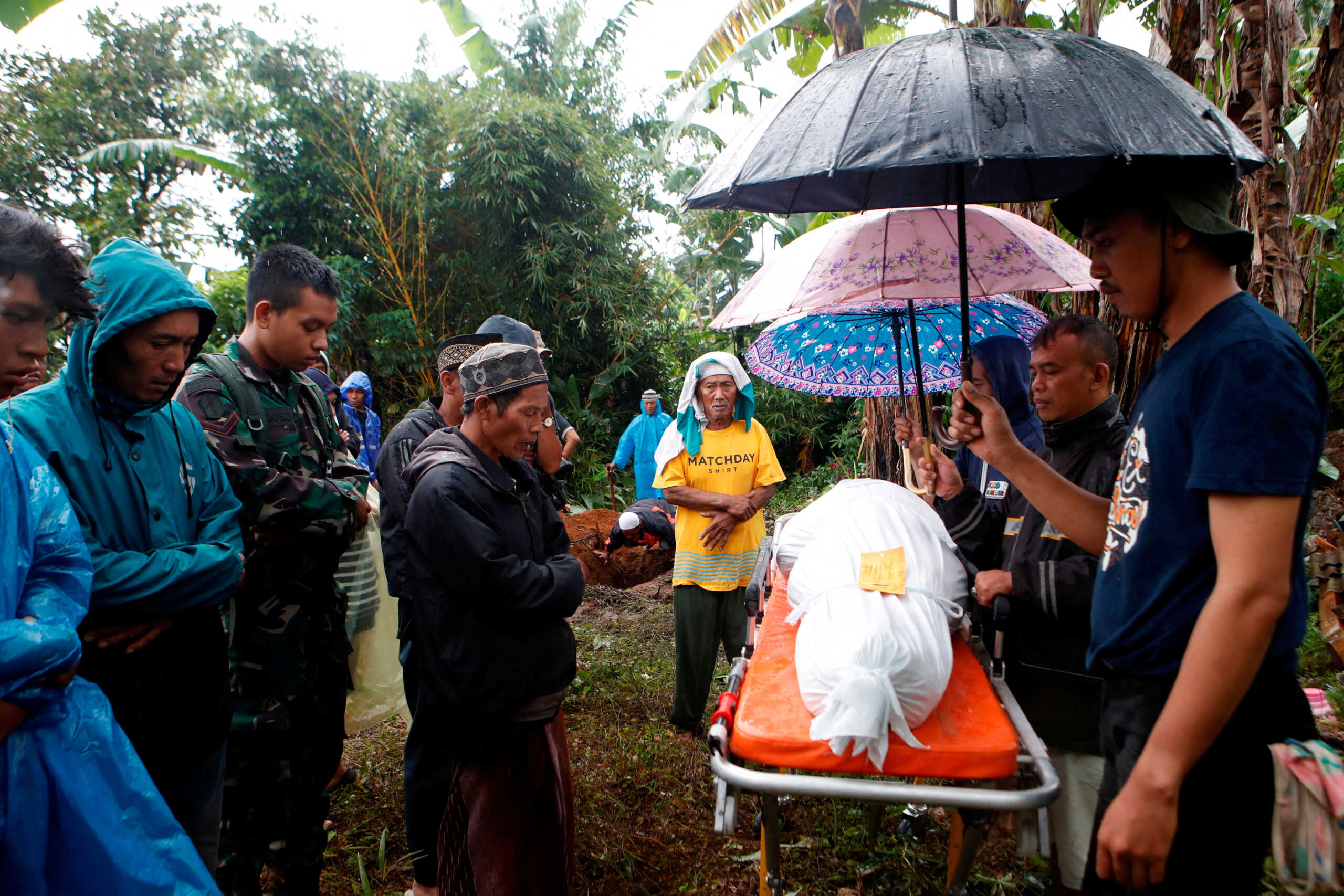 People pray for Yuni Rohaini, 23, who died in the earthquake before the funeral in Sukamulya, in Cianjur, West Java province, Indonesia, November 23, 2022. REUTERS