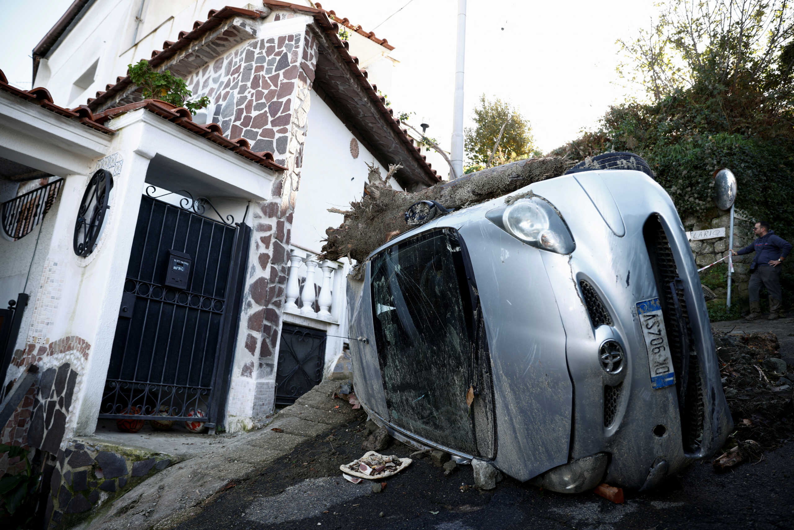 A damaged car is seen among debris, following a landslide on the Italian island of Ischia, Italy November 28, 2022. REUTERS
