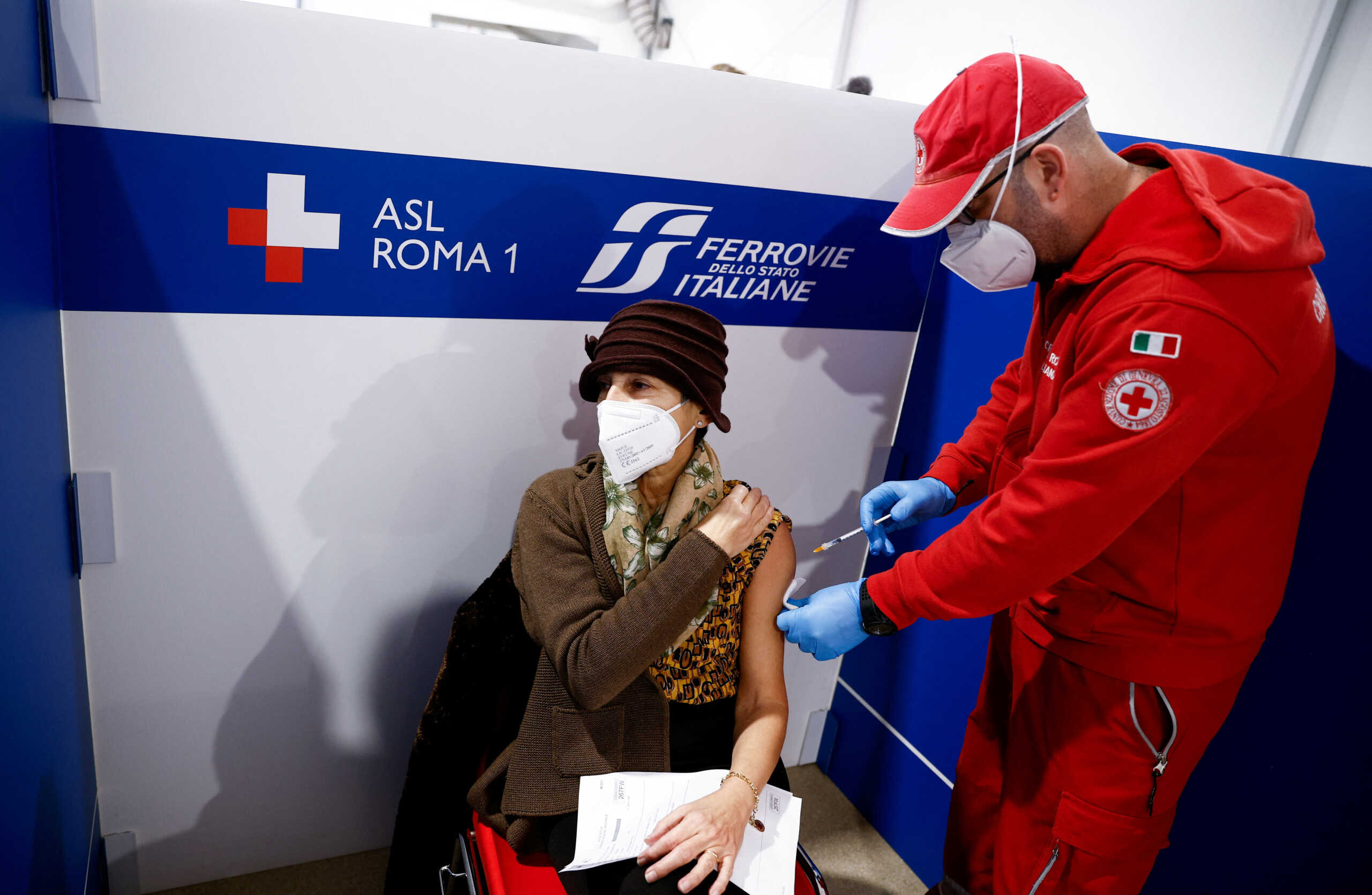 FILE PHOTO: A woman receives a dose of the vaccine against the coronavirus disease (COVID-19), on the day Italy brings in tougher rules for the unvaccinated, at a Red Cross vaccination centre by Termini main train station in Rome, Italy, January 10, 2022. REUTERS