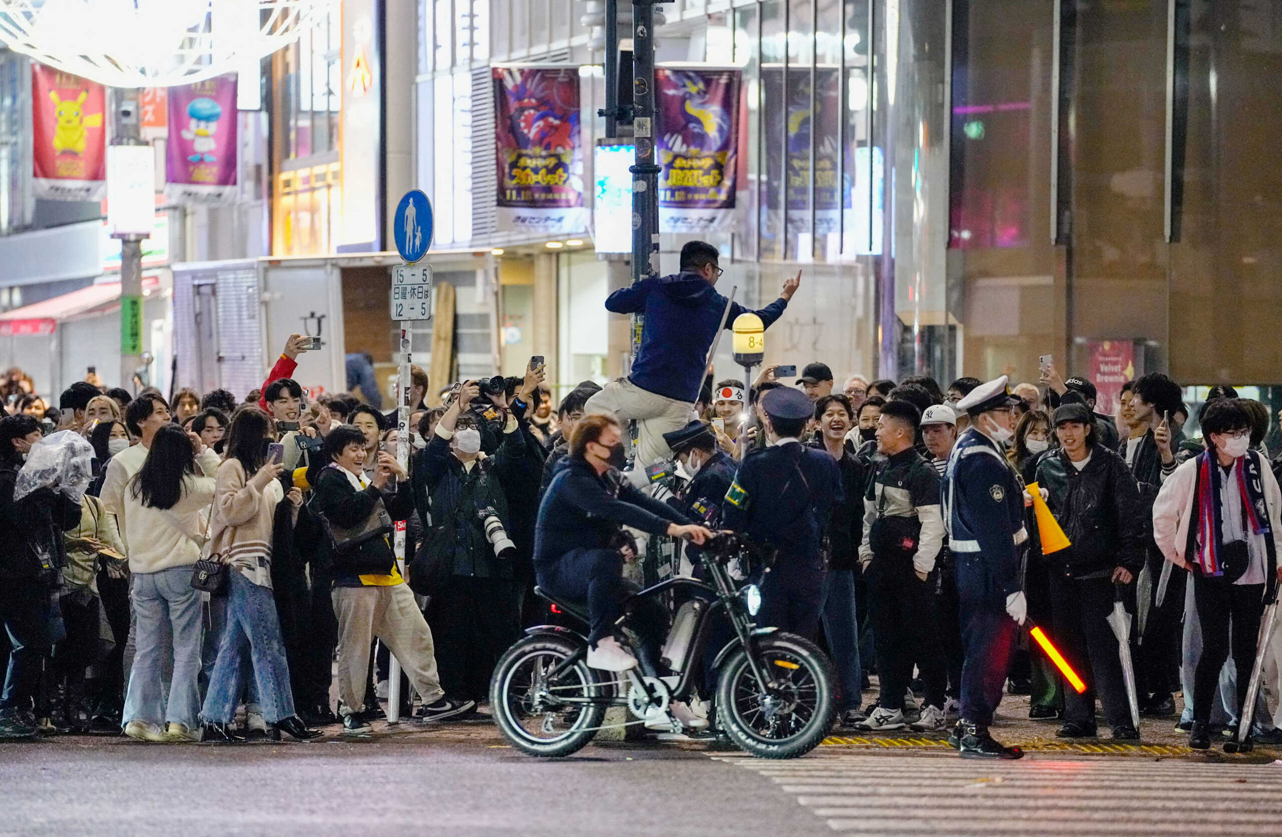 Japanese soccer fans celebrate after Japan won a FIFA World Cup Qatar 2022 match with Germany, at Shibuya crossing in Tokyo, Japan November 23, 2022. Kyodo