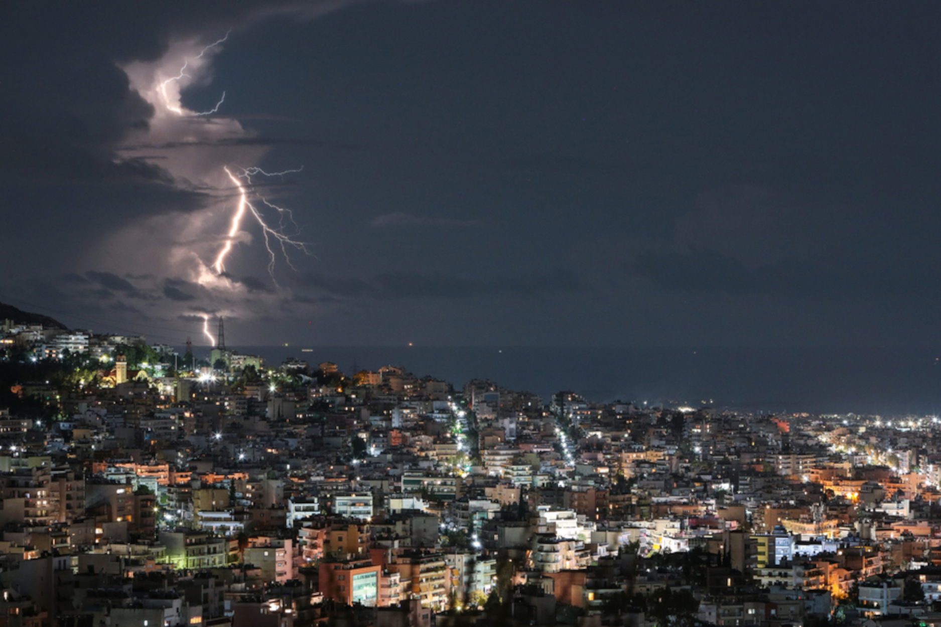 Κεραυνοί διακρίνονται στον ορίζοντα από την πόλη του Βύρωνα στην Αθήνα, Κυριακή 06 Νοεμβρίου 2022. Σύμφωνα με το Έκτακτο Δελτίο Επικίνδυνων Καιρικών Φαινομένων που εκδόθηκε σήμερα Κυριακή 6 Νοεμβρίου 2022, από την Εθνική Μετεωρολογική Υπηρεσία (ΕΜΥ) και αφορά στην εξέλιξη της κακοκαιρίας "EVA", επικαιροποιείται σύμφωνα με τα τελευταία προγνωστικά στοιχεία. Επικίνδυνα καιρικά φαινόμενα θα συνεχίζουν να εκδηλώνονται κατά τόπους στη χώρα μας σήμερα Κυριακή (06-11-22) και έως τις πρώτες πρωινές ώρες της Δευτέρας (07-11-22). Η κακοκαιρία έχει ως κύρια χαρακτηριστικά τα μεγάλα ύψη βροχής, τις μεγάλες ραγδαιότητες και τη μεγάλη συχνότητα κεραυνών. ΑΠΕ-ΜΠΕ