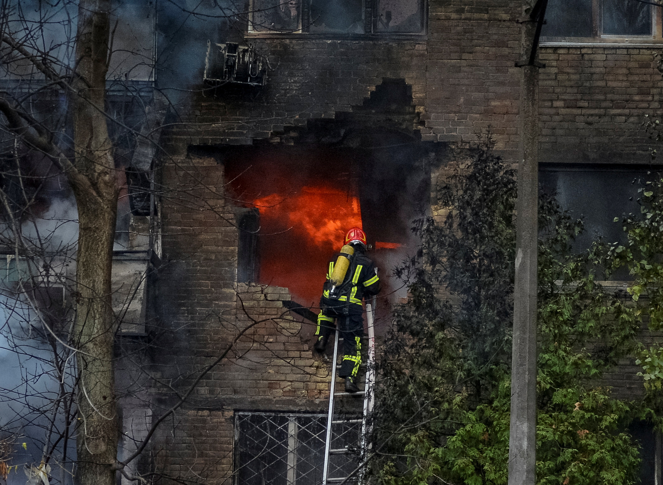 Firefighters work to put out a fire in a residential building hit by a Russian missile strike, amid Russia's attack on Ukraine, in Kyiv, Ukraine November 15, 2022. REUTERS