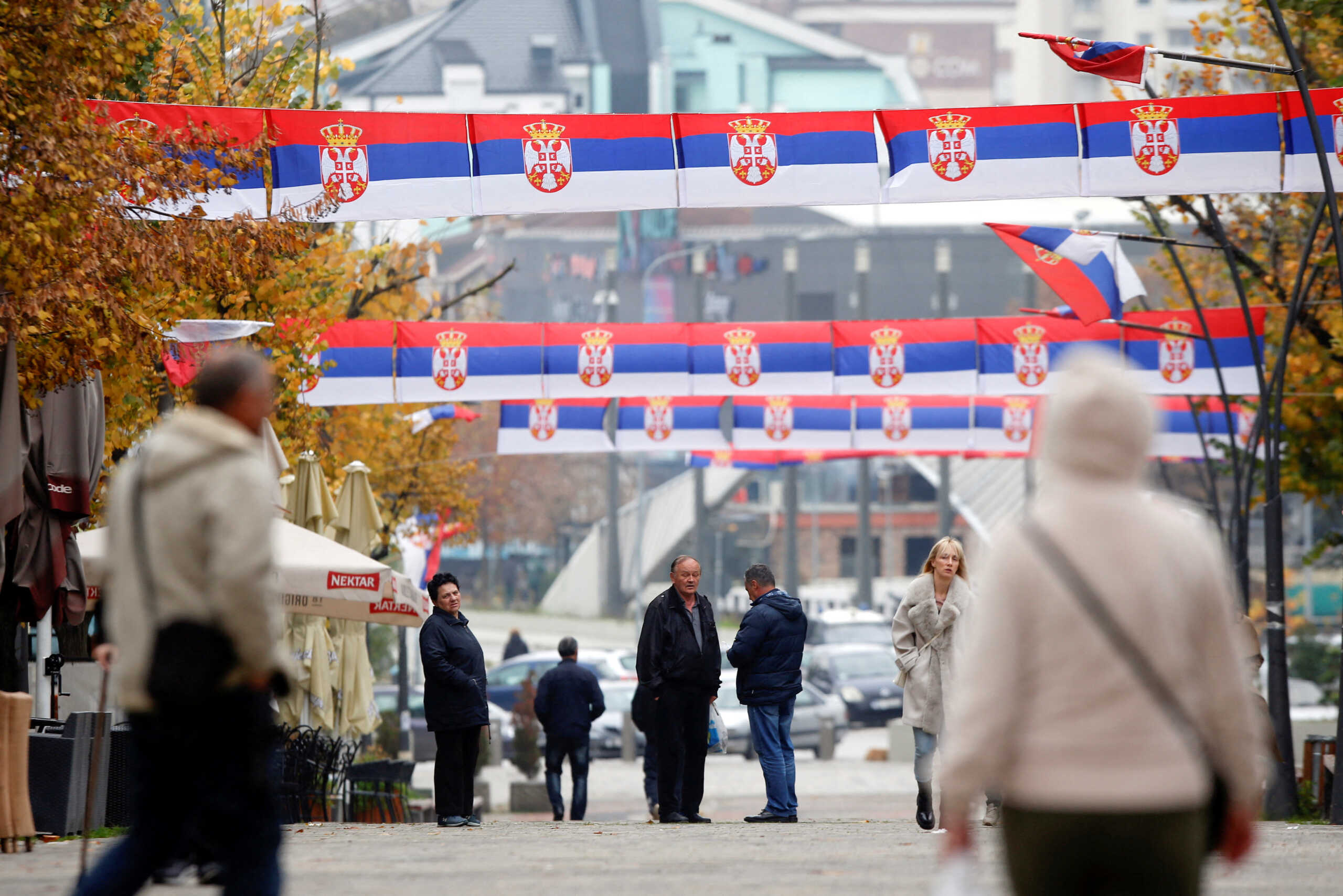 People walk at the square in North of Mitrovica, Kosovo, November 22, 2022. REUTERS