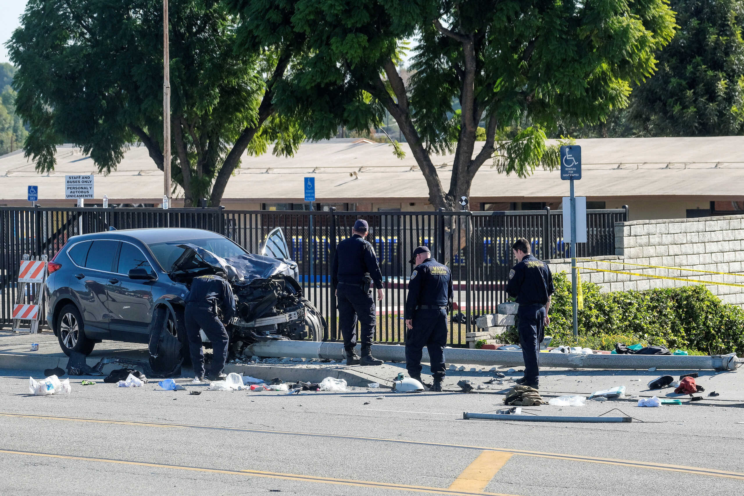 Law enforcement investigate the scene after multiple Los Angeles County Sheriff's Department recruits were injured when a car crashed into them while they were out for a run in Whittier, California, U.S. November 16, 2022. REUTERS