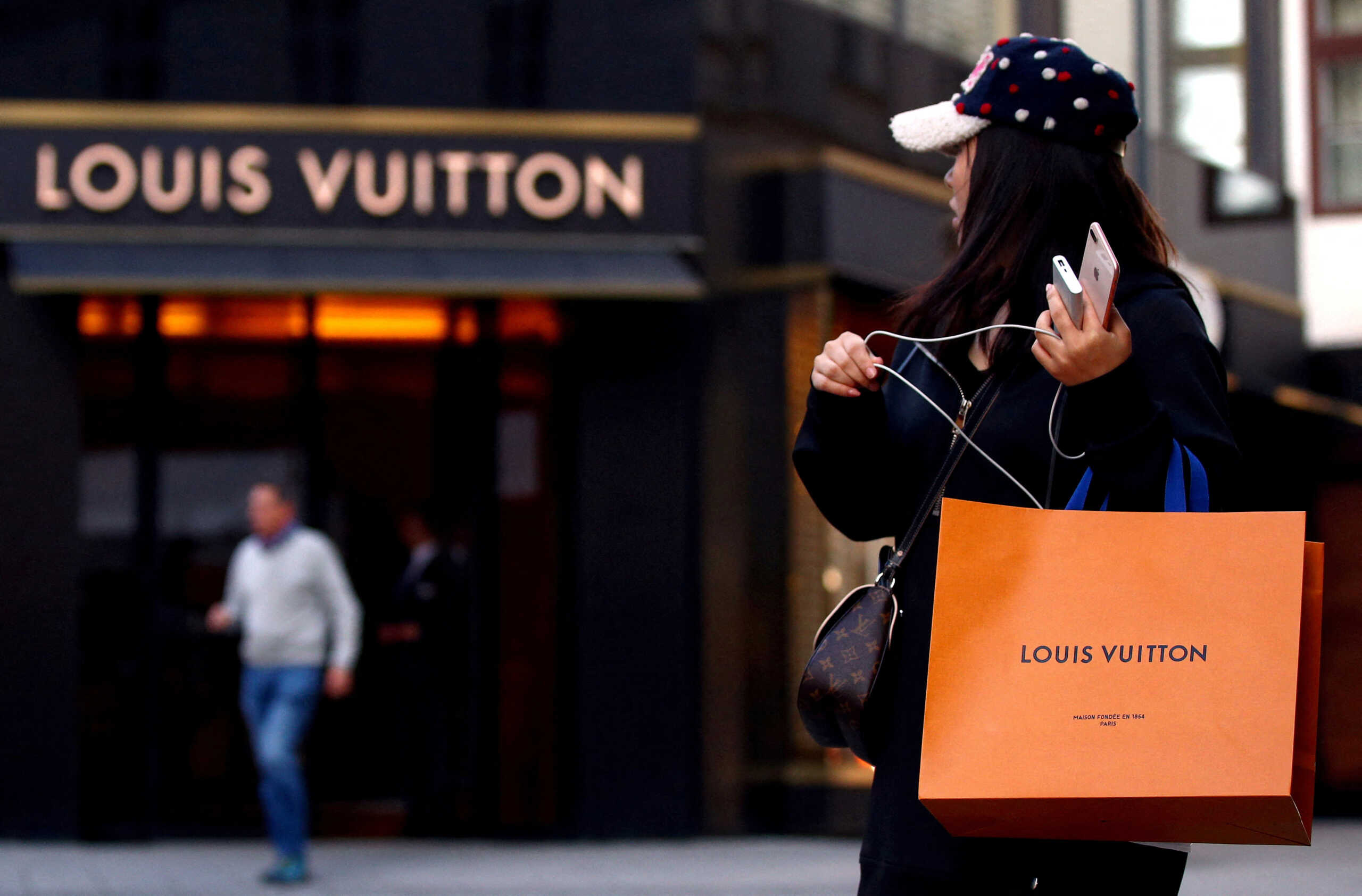 FILE PHOTO: FILE PHOTO: A woman with a Louis Vuitton-branded shopping bag in Vienna, Austria October 4, 2018. REUTERS