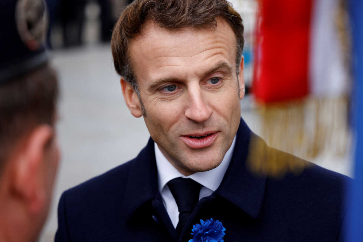 France's President Emmanuel Macron talks with flag-bearing veterans during a ceremony at the Arc de Triomphe as part of commemorations marking the 104th anniversary of the November 11, 1918 Armistice ending World War I (WWI), in Paris, France November 11, 2022. Ludovic Marin