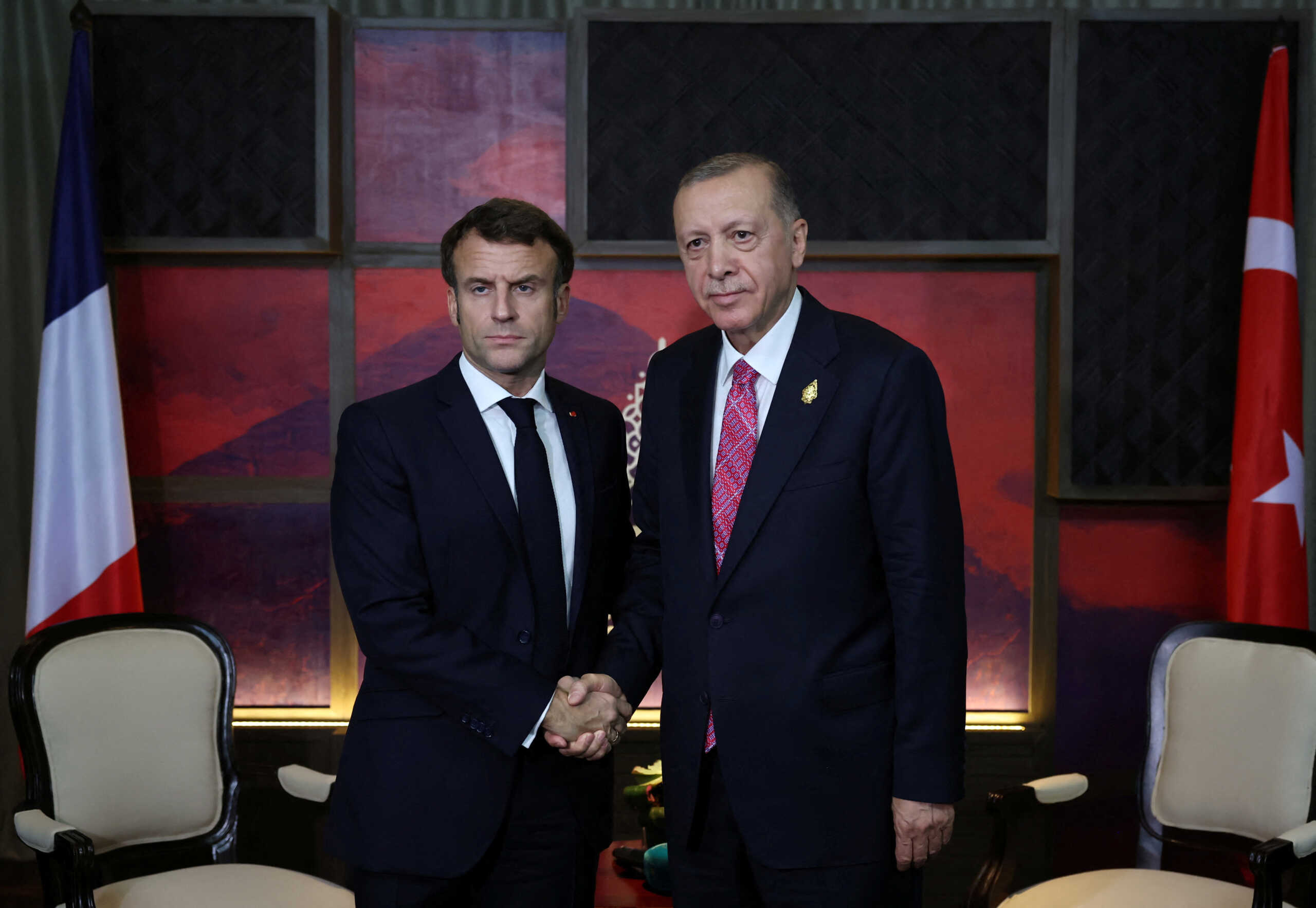 Turkey's President Tayyip Erdogan shakes hands with French President Emmanuel Macron during the G20 leaders' summit in Nusa Dua, Bali, Indonesia, November 15, 2022. Murat Cetinmuhurdar