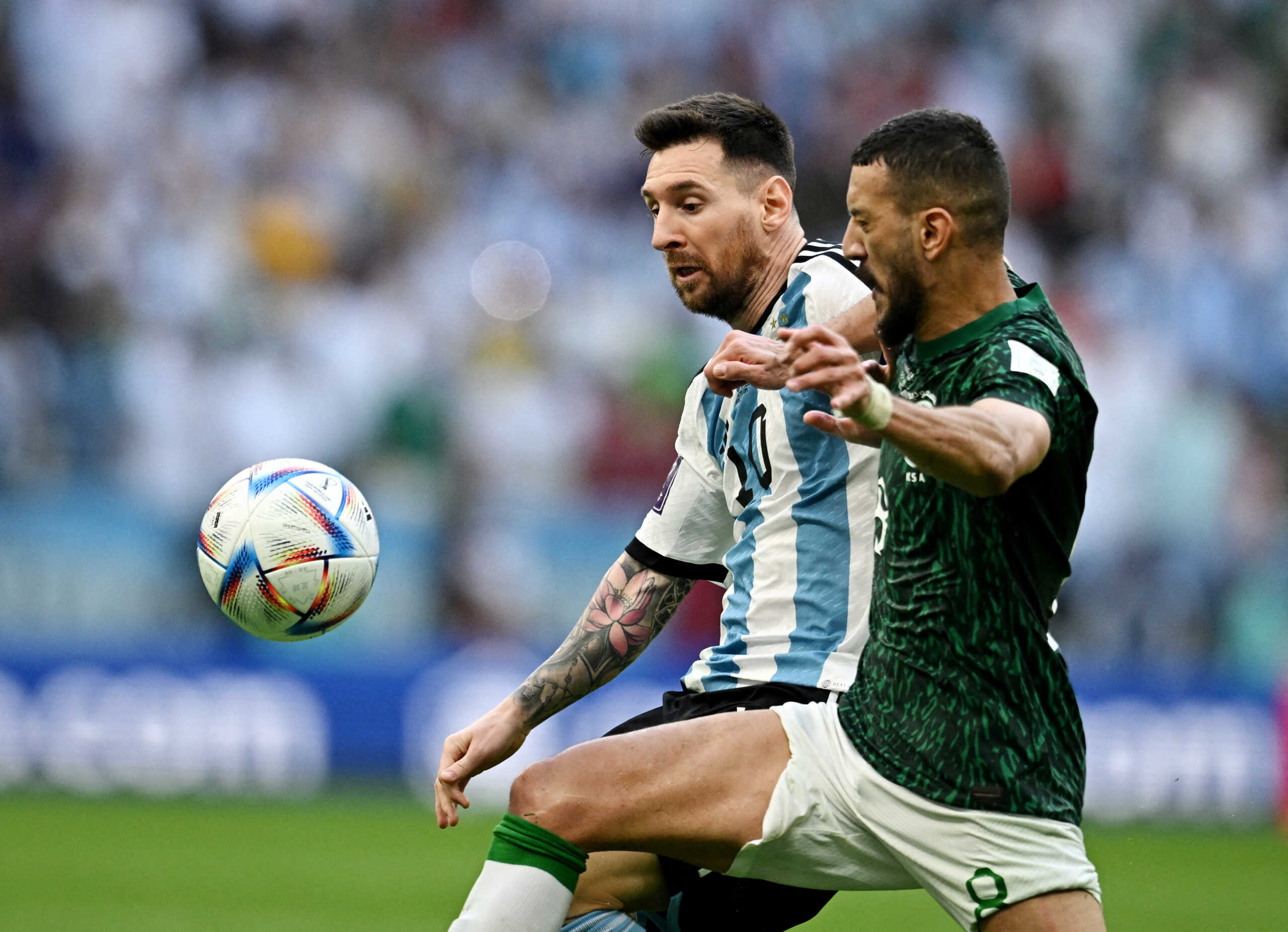 Soccer Football - FIFA World Cup Qatar 2022 - Group C - Argentina v Saudi Arabia - Lusail Stadium, Lusail, Qatar - November 22, 2022  Argentina's Lionel Messi in action with Saudi Arabia's Abdulellah Al-Malki REUTERS