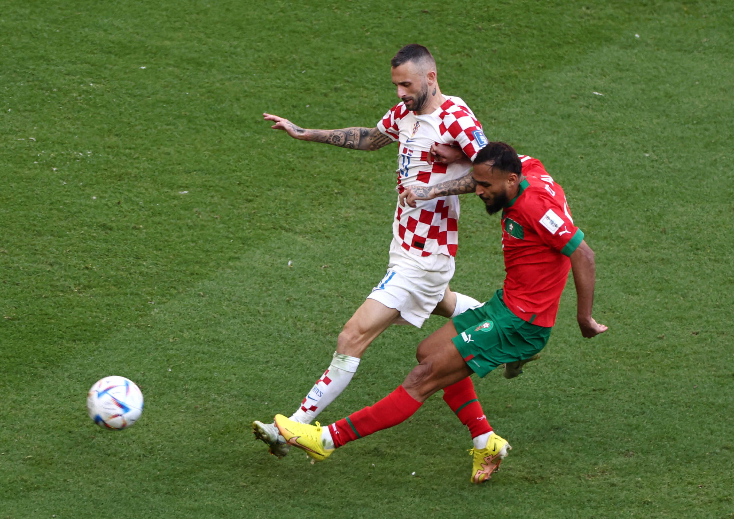 Soccer Football - FIFA World Cup Qatar 2022 - Group F - Morocco v Croatia - Al Bayt Stadium, Al Khor, Qatar - November 23, 2022 Croatia's Marcelo Brozovic in action with Morocco's Sofiane Boufal REUTERS
