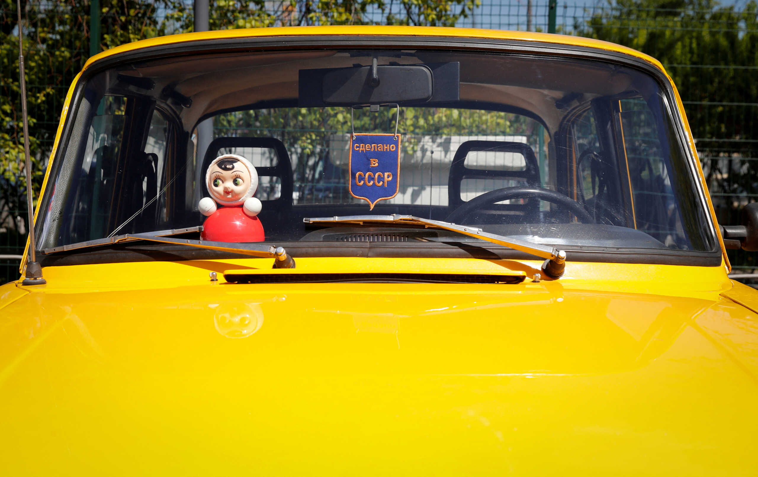 FILE PHOTO: A Roly Poly Nevalyashka doll is seen inside a car during a gathering of Soviet-era Moskvich cars owners and enthusiasts in Moscow, Russia May 21, 2022. Picture taken May 21, 2022. The sign reads: "Made in USSR". REUTERS