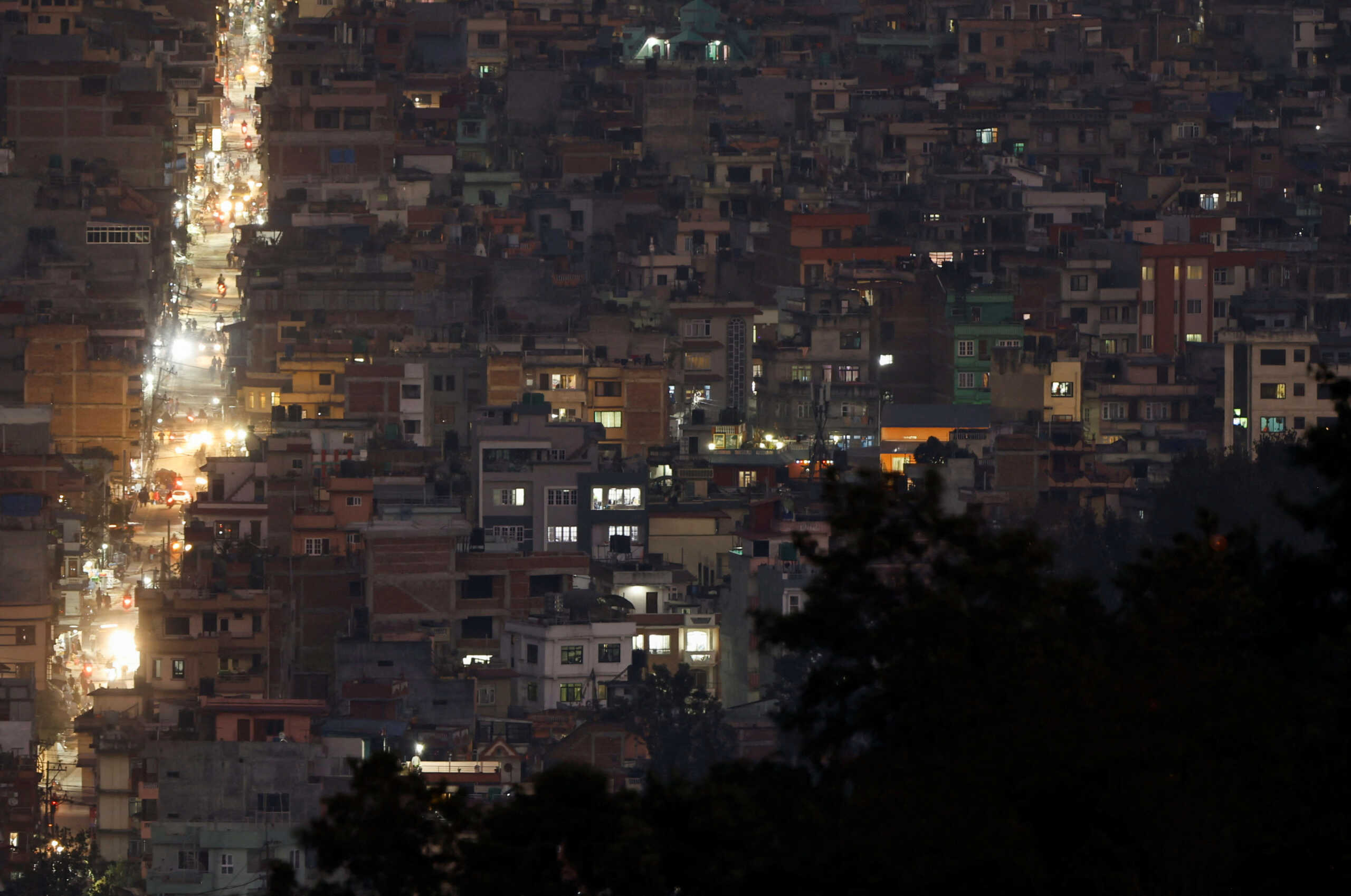 Light illuminates a street between the cluster of residential buildings in Kathmandu, Nepal November 8, 2022. REUTERS