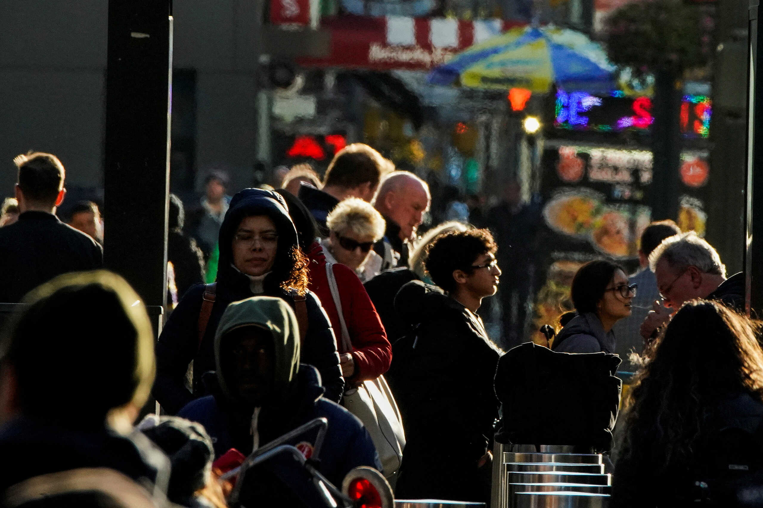 People walk on the New York City street of 9th Avenue in Manhattan as according to a United Nations report, the world's population is estimated to reach 8 billion by November 15 of this year, in New York, U.S., November 14, 2022. REUTERS
