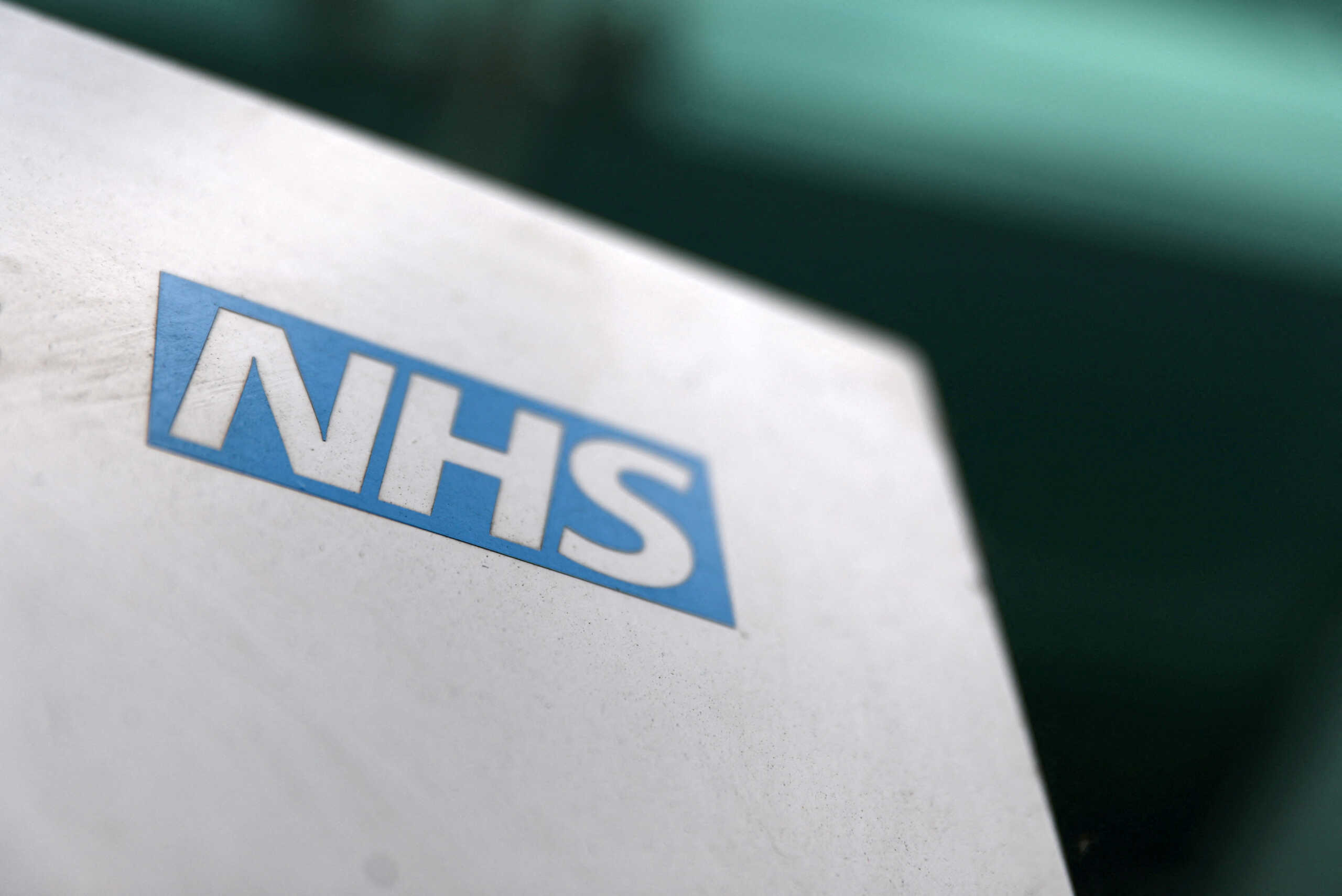 FILE PHOTO: An NHS logo is displayed outside a hospital in London, Britain May 14, 2017. REUTERS