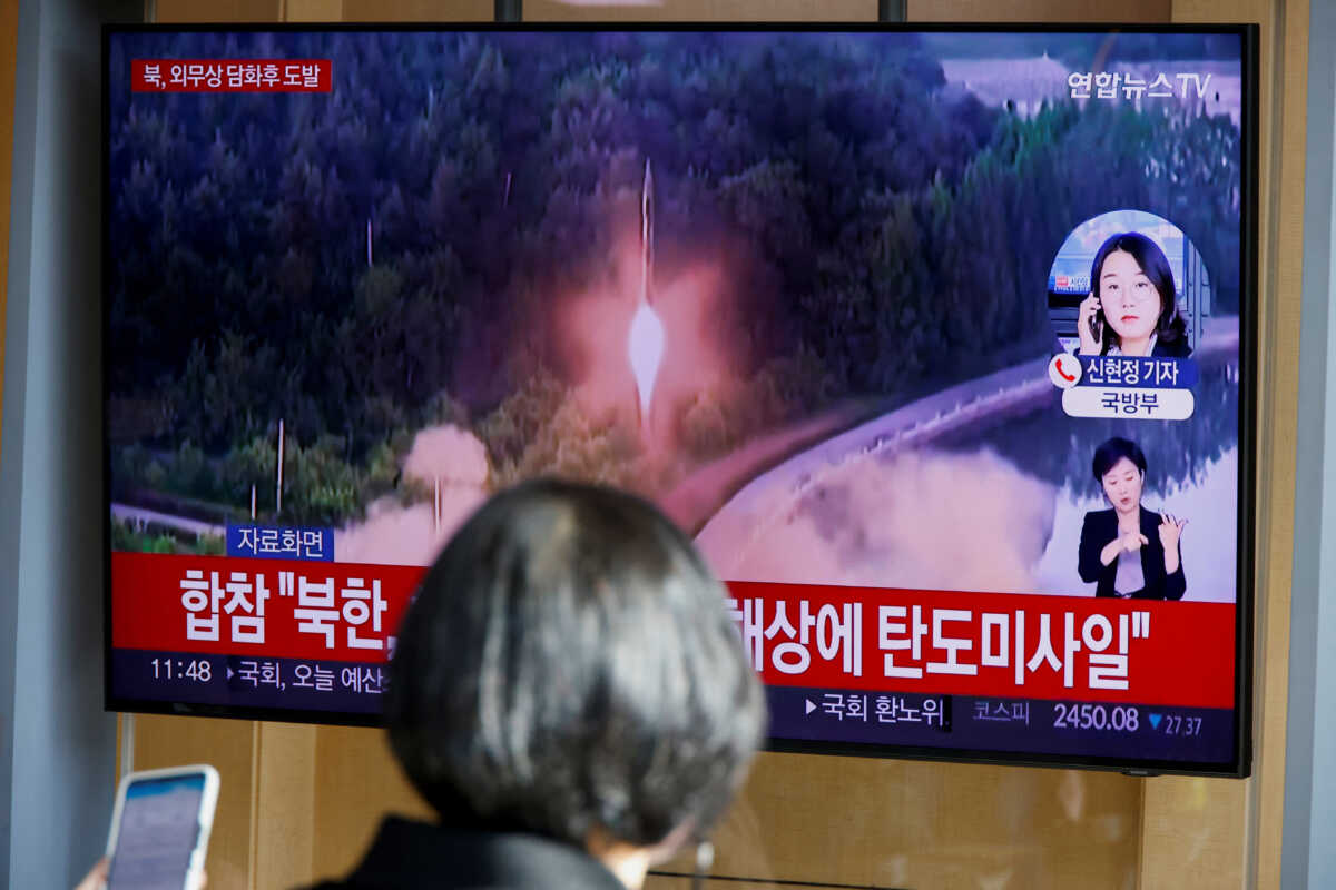 A woman watches a TV broadcasting a news report, on North Korea firing a ballistic missile off its east coast, in Seoul, South Korea, November 17, 2022.  REUTERS