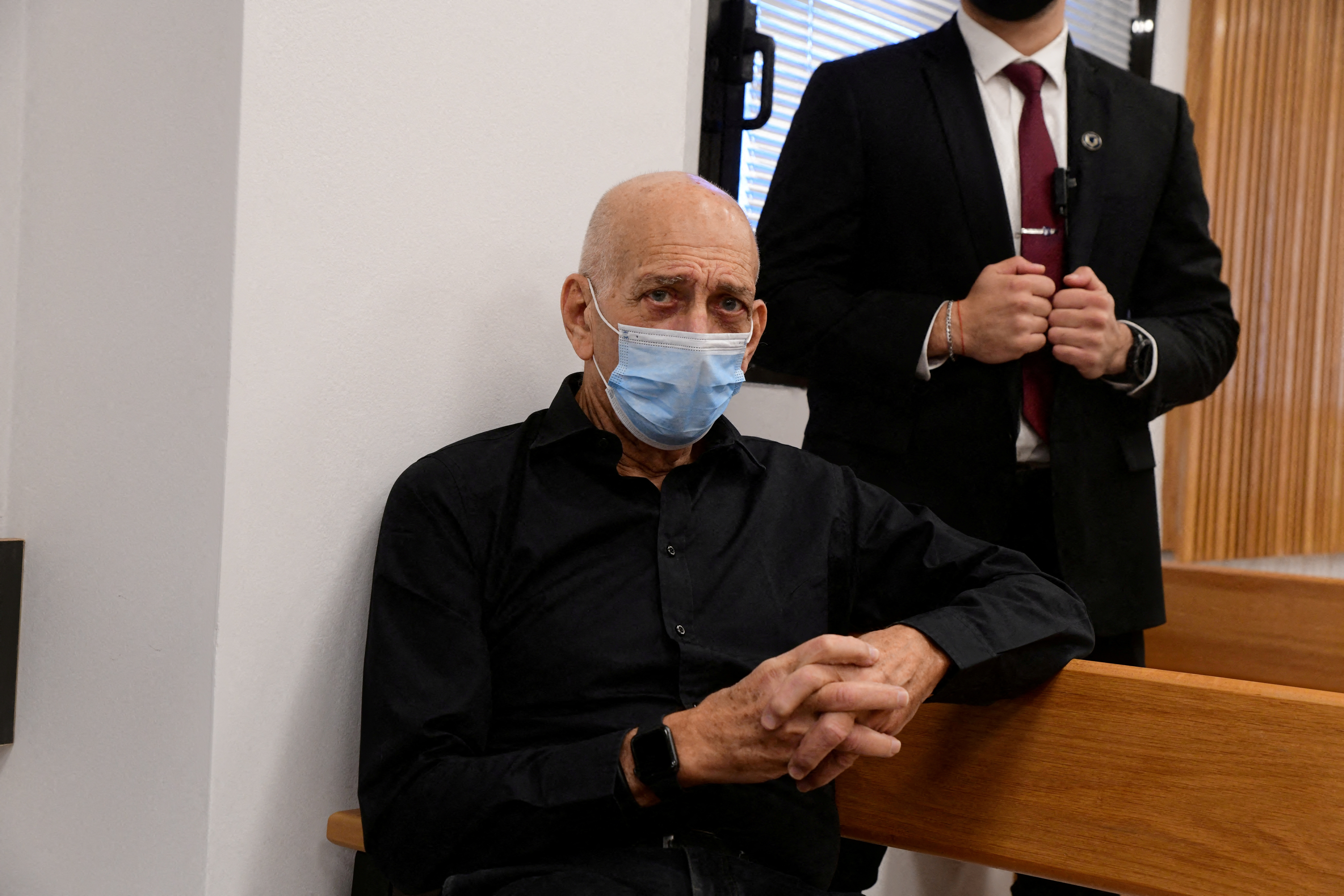 FILE PHOTO: Former Israeli Prime Minister Ehud Olmert attends a preliminary hearing of the defamation lawsuit filed against him by Former Israeli Prime Minister Benjamin Netanya, his wife Sara and son Yair, in Magistrate Court in Tel Aviv, Israel, January 10, 2022. Avshalom Sassoni