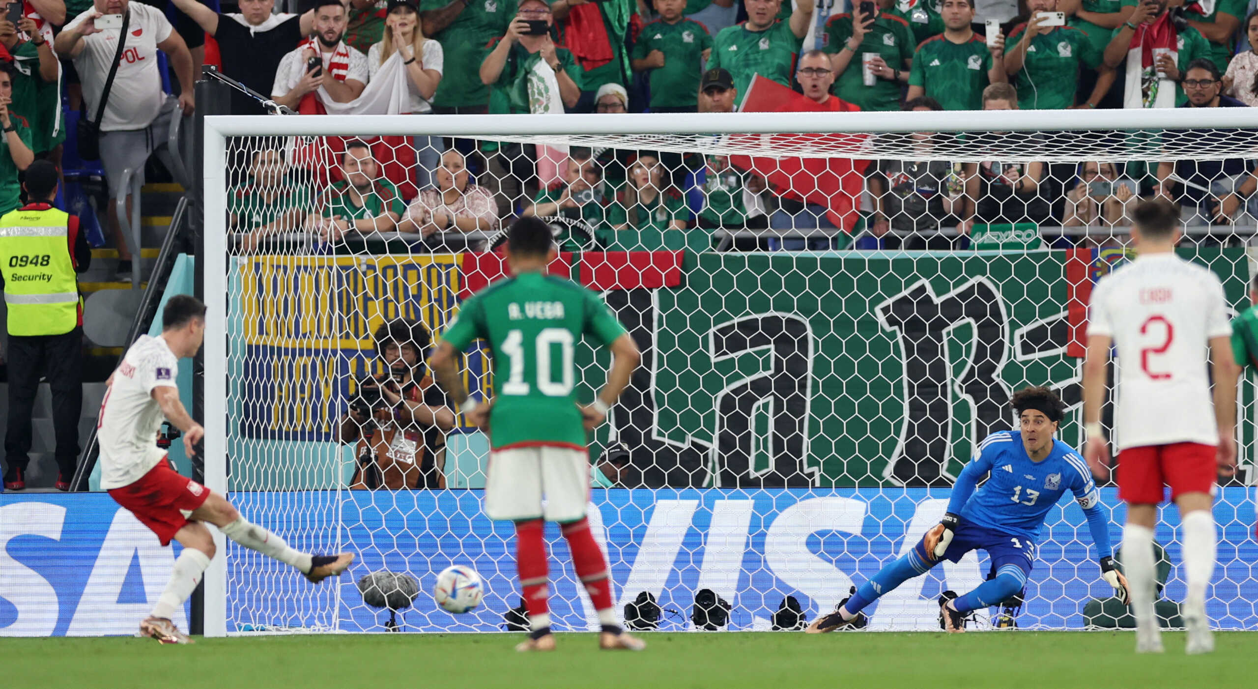 Soccer Football - FIFA World Cup Qatar 2022 - Group C - Mexico v Poland - Stadium 974, Doha, Qatar - November 22, 2022  Mexico's Guillermo Ochoa saves a penalty missed by Poland's Robert Lewandowski REUTERS