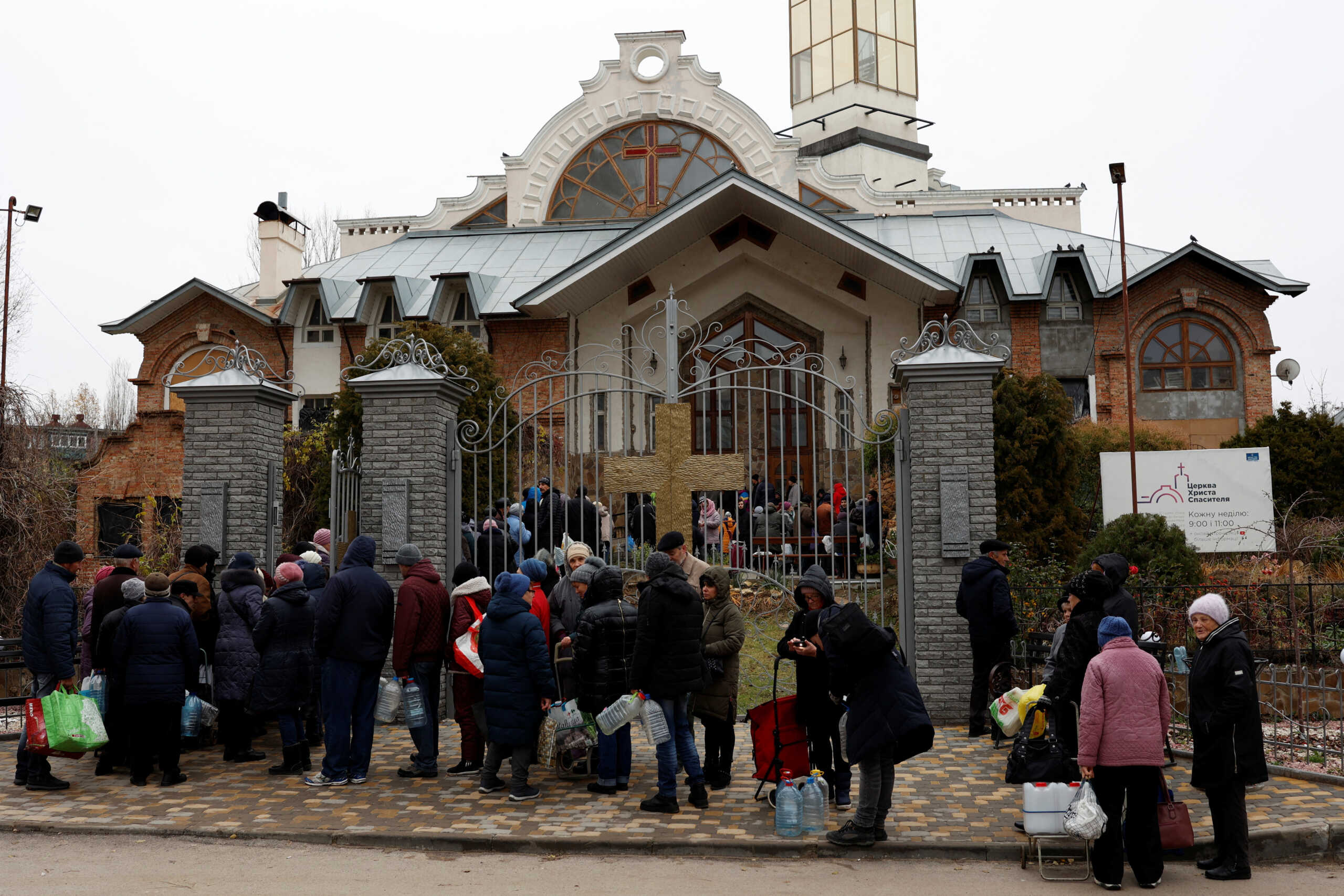 People wait in line to get food, water and aid after Russia's military retreat from Kherson, outside the Church of Christ the Savior in Kherson, Ukraine November 22, 2022. REUTERS