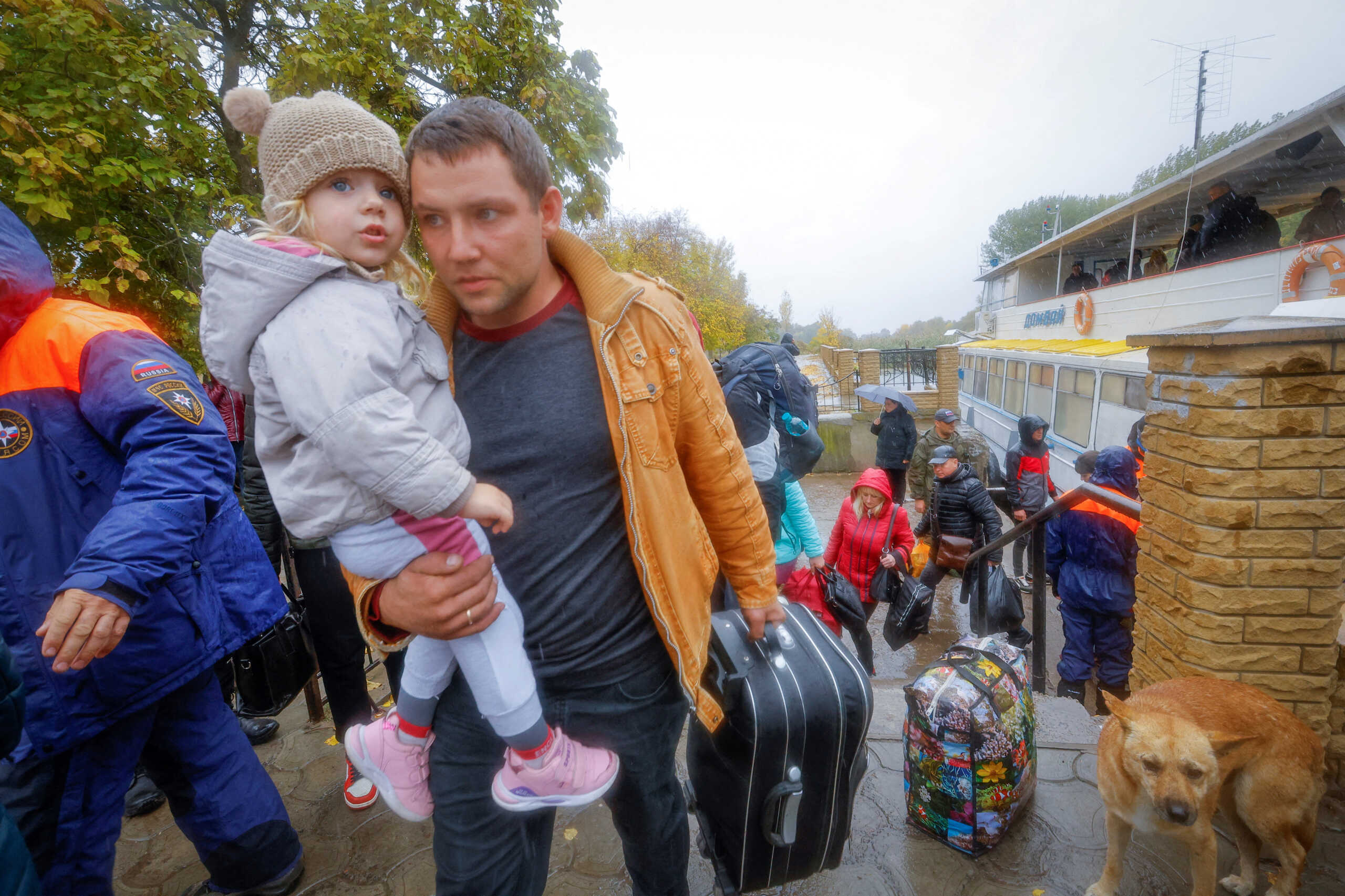 Civilians evacuated from the Russian-controlled city of Kherson walk from a ferry to board a bus heading to Crimea, in the town of Oleshky, Kherson region, Russian-controlled Ukraine October 23, 2022. REUTERS