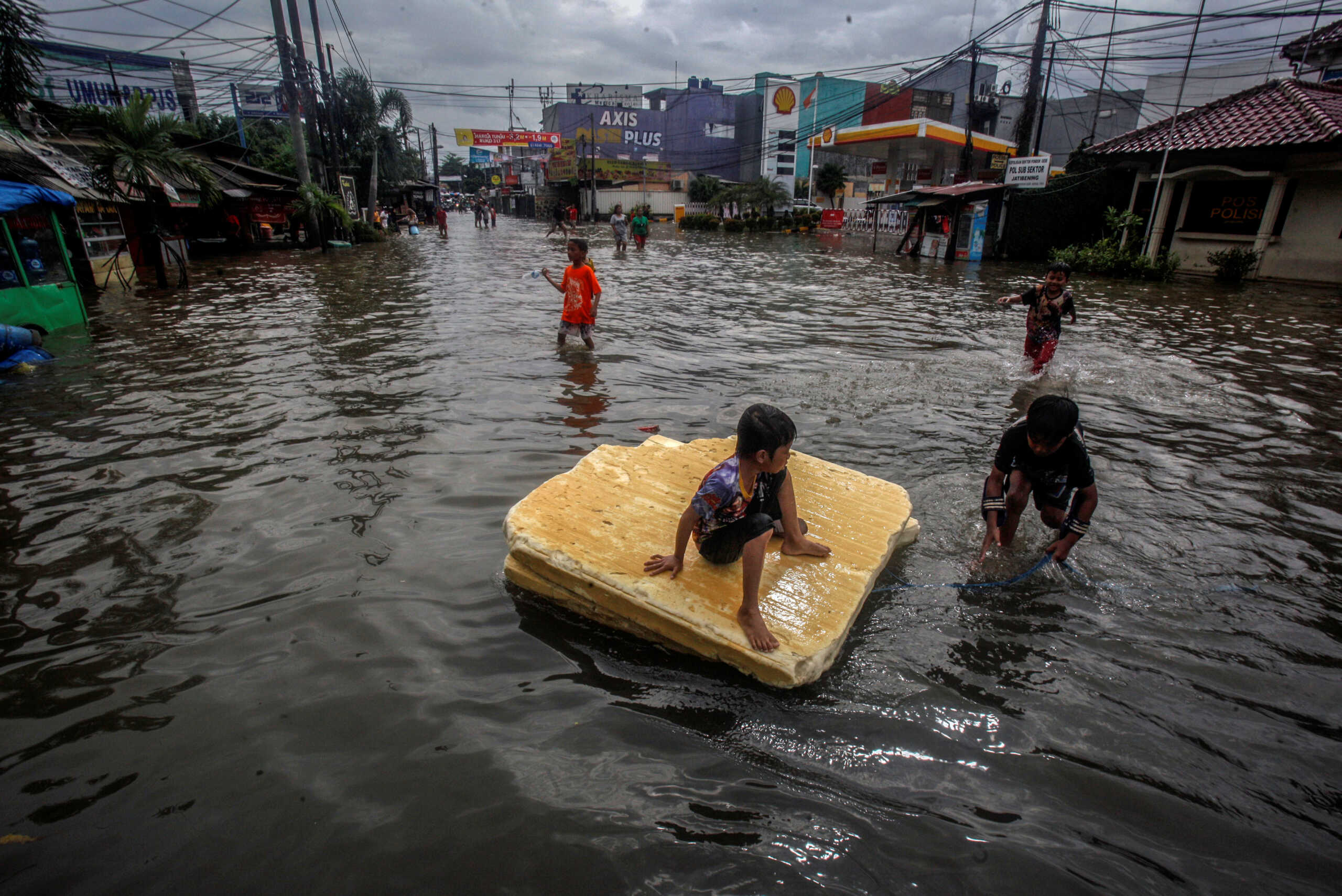 Children play in the floodwaters after heavy rains in Bekasi, near Jakarta, Indonesia February 25, 2020 in this photo taken by Antara Foto.  Antara Foto