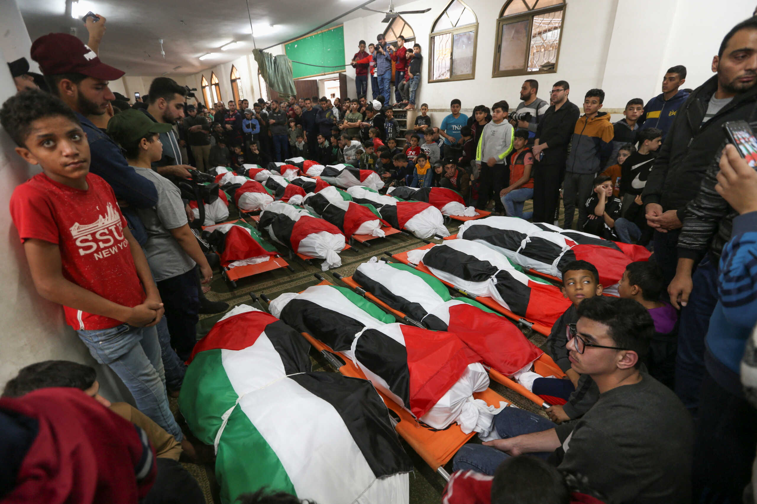 Palestinians attend the funeral of 21 people who were killed in a fire that broke out during a party in the Gaza Strip, according to health and civil emergency officials in the northern Gaza Strip, November 18, 2022. REUTERS