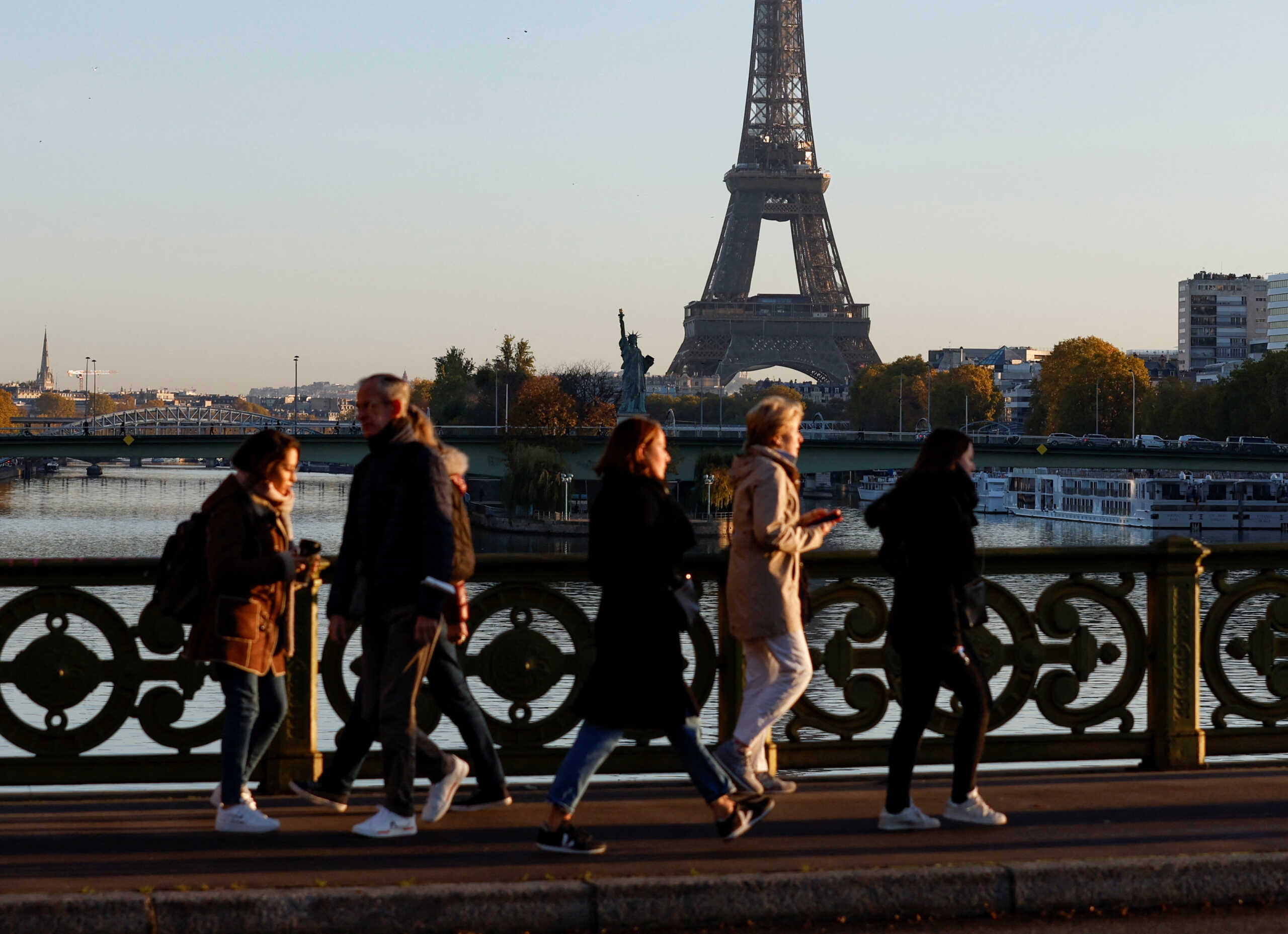 People walk near the Eiffel Tower during a nationwide strike for higher wages and pensions in Paris, France, November 10, 2022. REUTERS