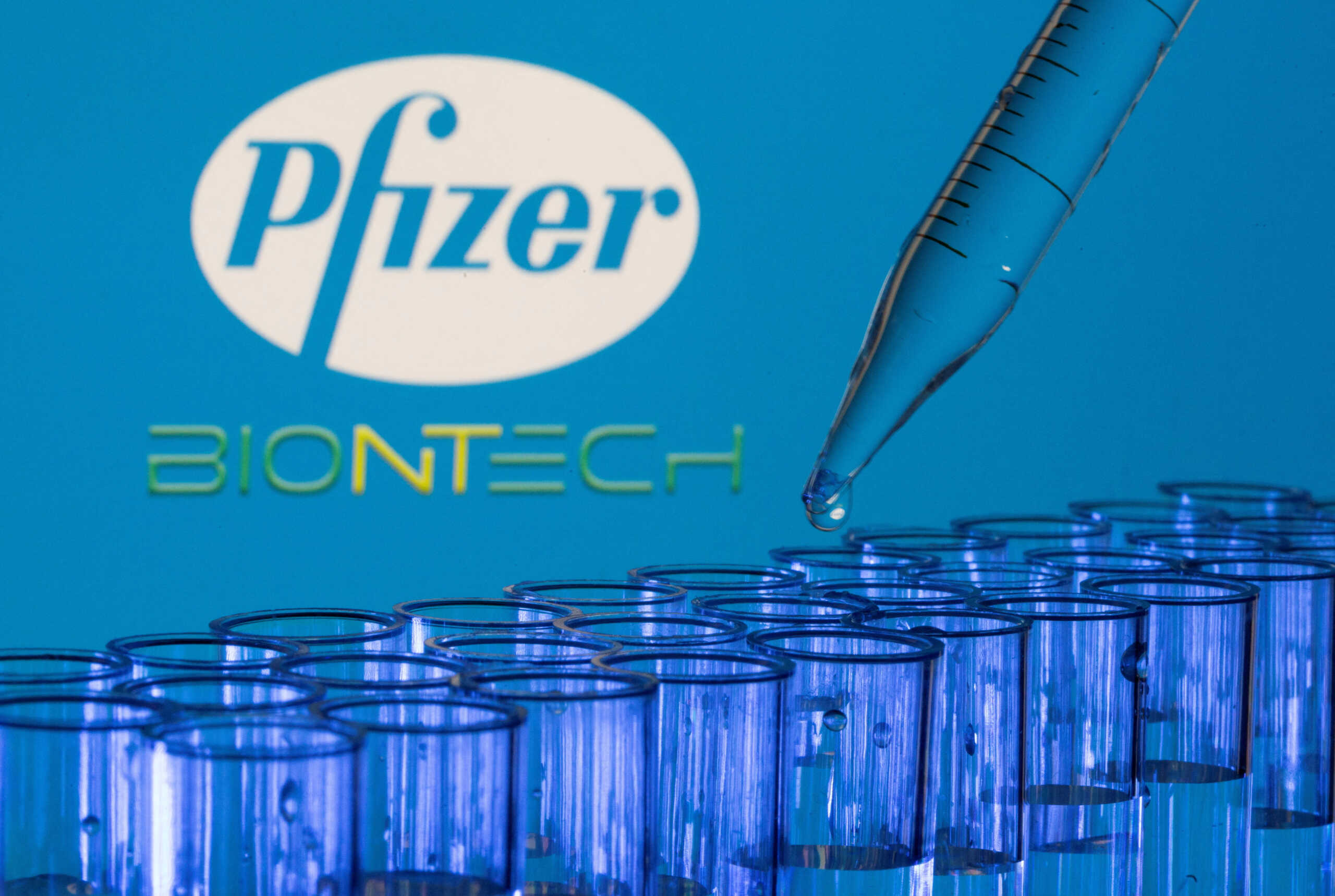 FILE PHOTO: Test tubes are seen in front of displayed Pfizer and Biontech logos in this illustration taken, May 21, 2021. REUTERS