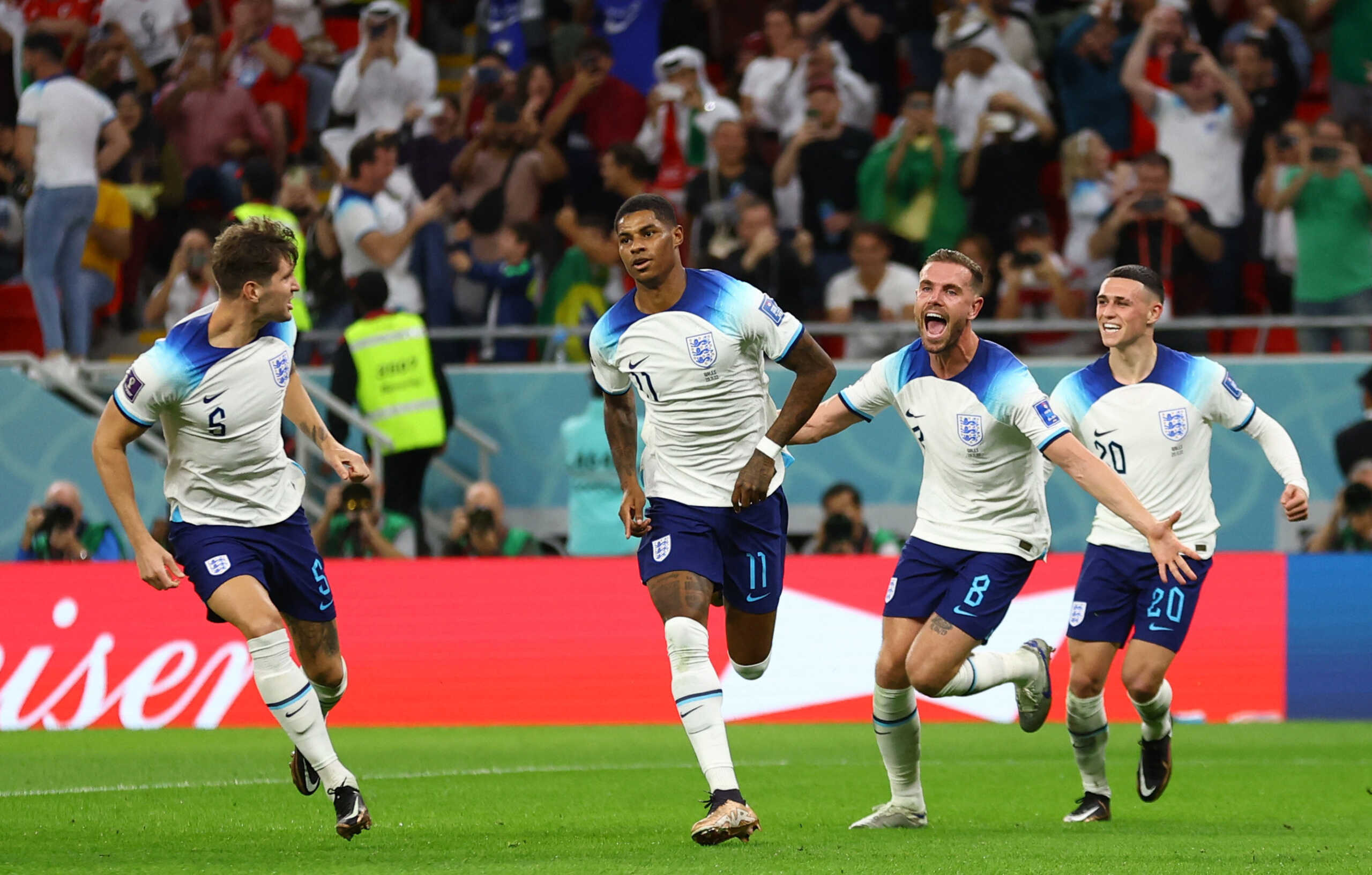 Soccer Football - FIFA World Cup Qatar 2022 - Group B - Wales v England - Ahmad Bin Ali Stadium, Al Rayyan, Qatar - November 29, 2022 England's Marcus Rashford celebrates scoring their first goal with John Stones, Jordan Henderson and Phil Foden REUTERS