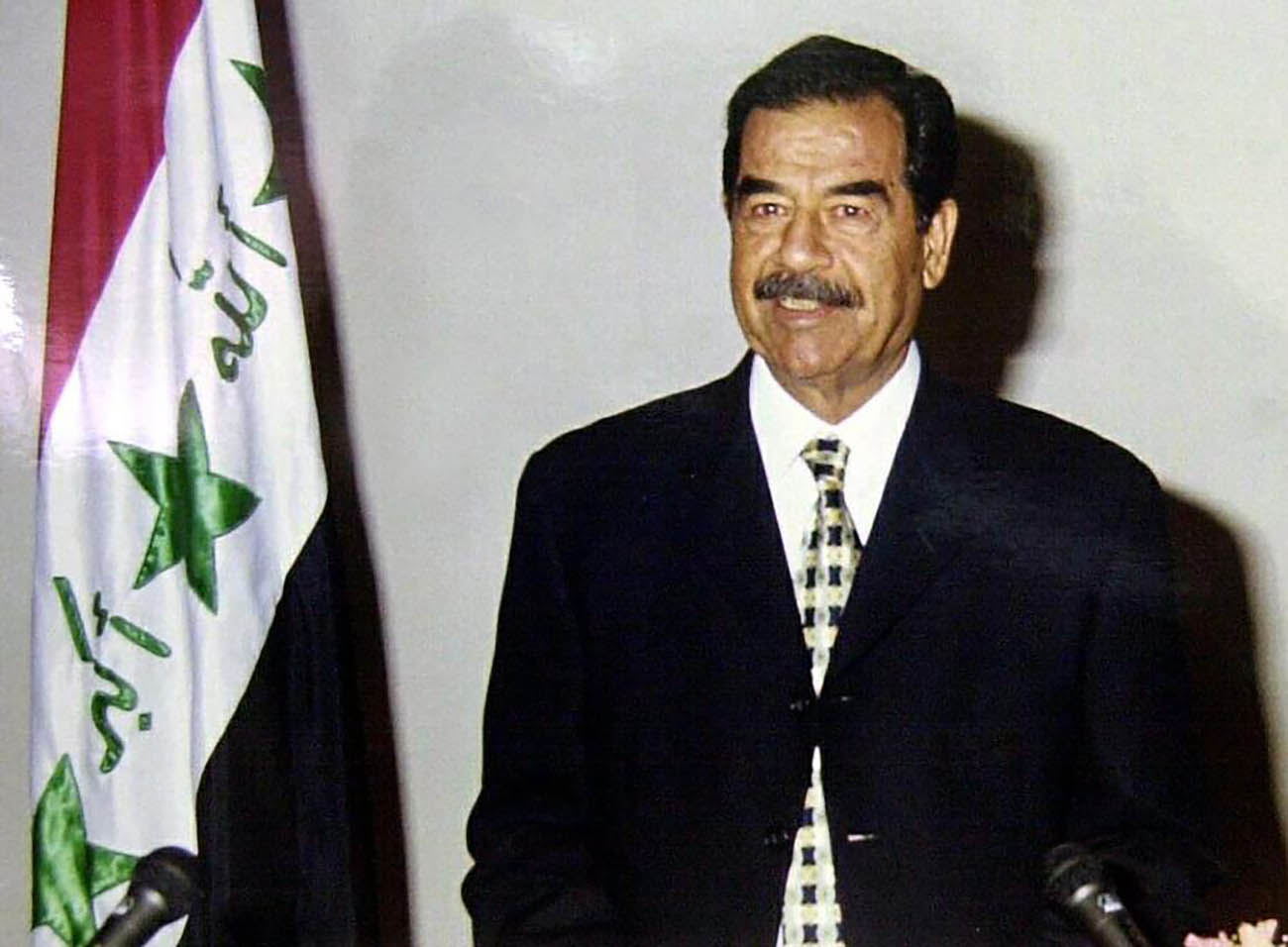 Picture released by the Iraqi News Agency shows 17 July 2001 Iraqi President Saddam Hussein during a 25-minute televised address to commemorate the 33rd anniversary of the coup that brought his Baath party to power. Saddam warned that oil was not Iraq's only weapon and urged Arab countries to take action against the "intolerable injustice" in Israel.  AFP PHOTO