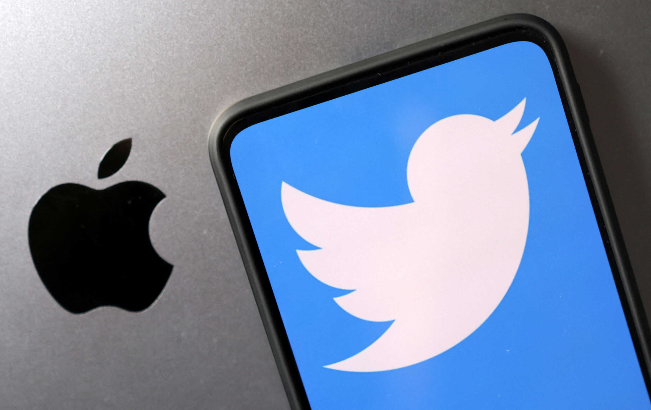 Smartphone with displayed Twitter logo is seen placed on Apple logo in this illustration taken, November 29, 2022. REUTERS