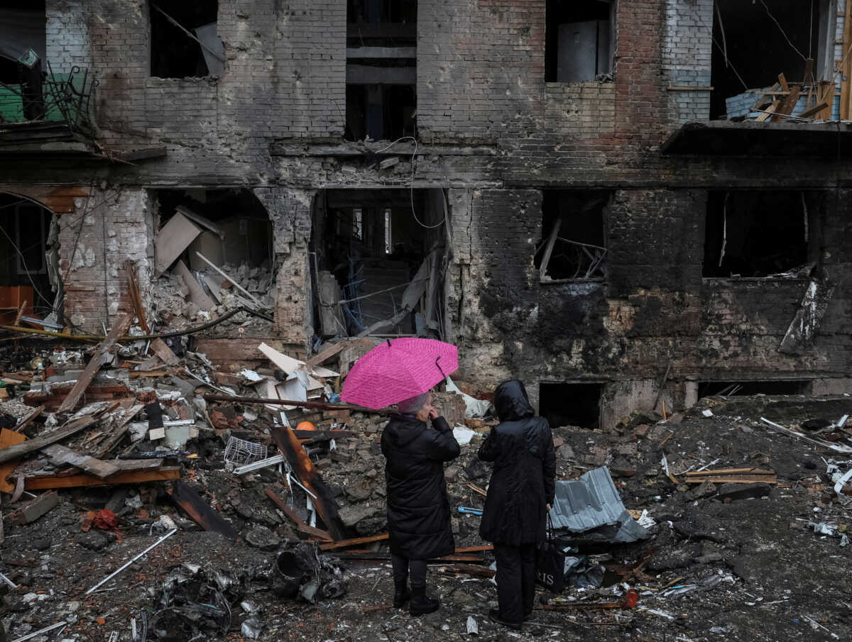 Local residents stand near their building destroyed by a Russian missile attack, as Russia's attack on Ukraine continues, in the town of Vyshhorod, near Kyiv, Ukraine November 24, 2022. REUTERS