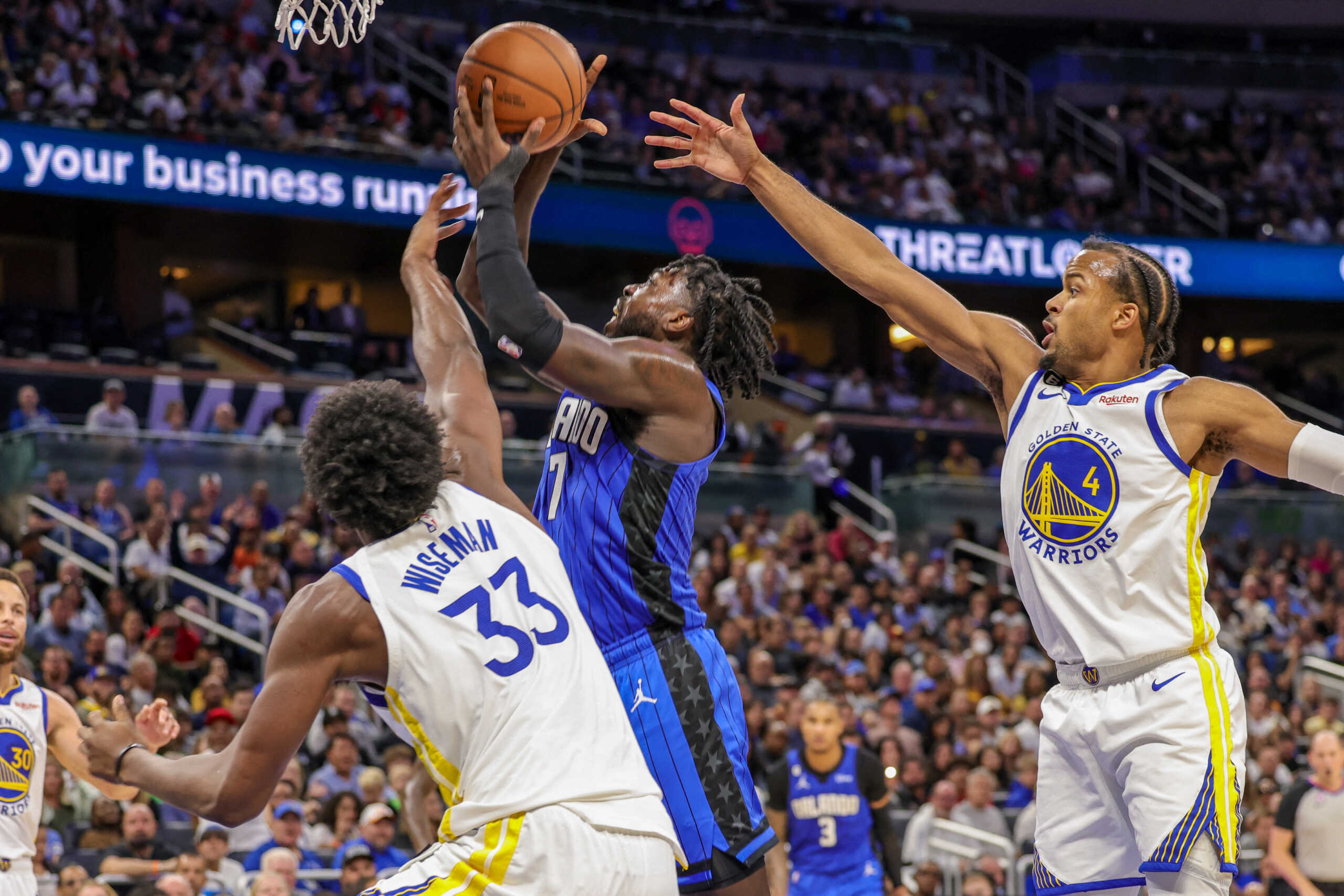 Nov 3, 2022; Orlando, Florida, USA; Orlando Magic guard Kevon Harris (7) goes to the basket against Golden State Warriors center James Wiseman (33) and guard Moses Moody (4) during the second half at Amway Center. Mandatory Credit: Mike Watters-USA TODAY Sports