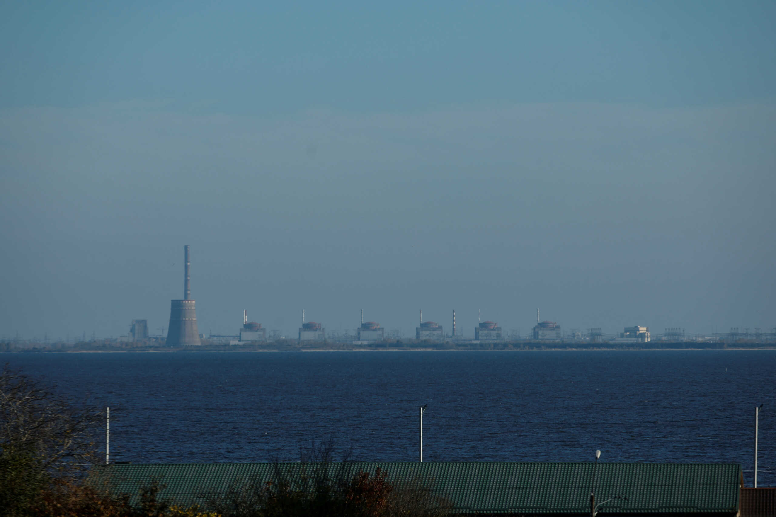 FILE PHOTO: A view shows Zaporizhzhia Nuclear Power Plant from the town of Nikopol, amid Russia's attack on Ukraine, in Dnipropetrovsk region, Ukraine November 7, 2022.  Picture taken through glass. REUTERS
