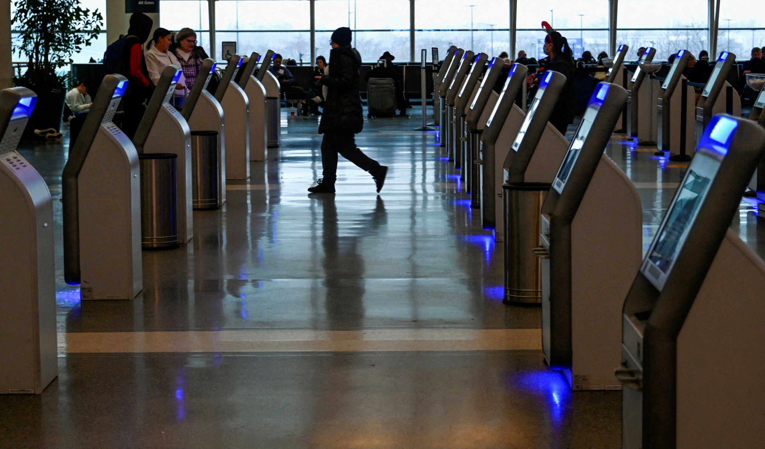 FILE PHOTO: Passengers arrive for their flight on Southwest Airlines as flight cancellations mount during a cold weather front as a weather phenomenon known as a bomb cyclone hits the Upper Midwest, at Midway International Airport in Chicago, Illinois, U.S., December 22, 2022. REUTERS