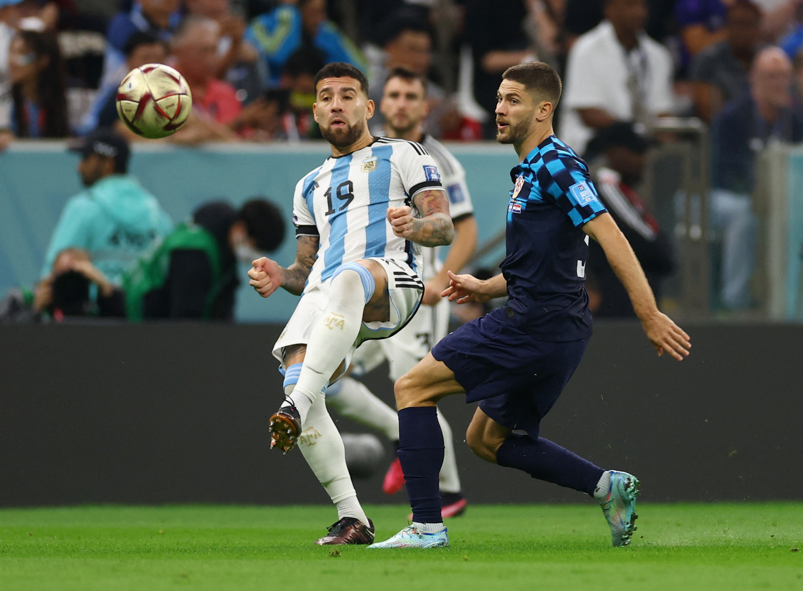 Soccer Football - FIFA World Cup Qatar 2022 - Semi Final - Argentina v Croatia - Lusail Stadium, Lusail, Qatar - December 13, 2022 Argentina's Nicolas Otamendi in action with Croatia's Andrej Kramaric REUTERS