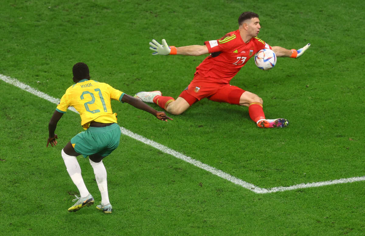 Soccer Football - FIFA World Cup Qatar 2022 - Round of 16 - Argentina v Australia - Ahmad bin Ali Stadium, Al Rayyan, Qatar - December 3, 2022 Argentina's Emiliano Martinez in action as he saves a shot from Australia's Garang Kuol REUTERS
