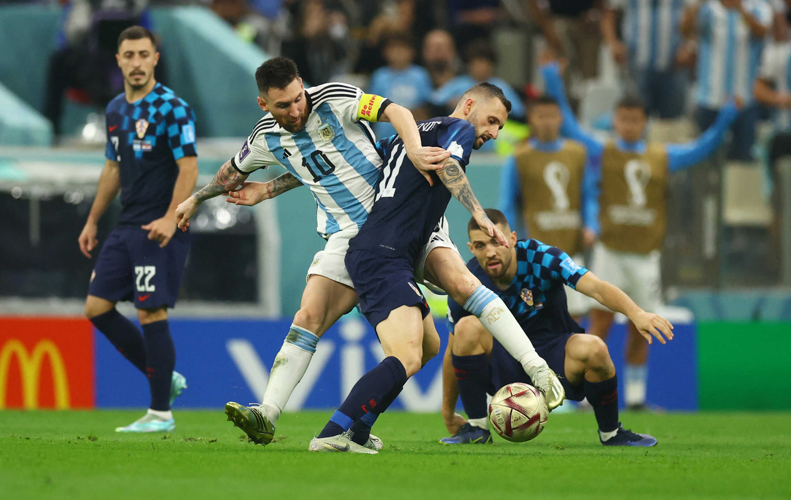 Soccer Football - FIFA World Cup Qatar 2022 - Semi Final - Argentina v Croatia - Lusail Stadium, Lusail, Qatar - December 13, 2022 Argentina's Lionel Messi in action with Croatia's Marcelo Brozovic REUTERS