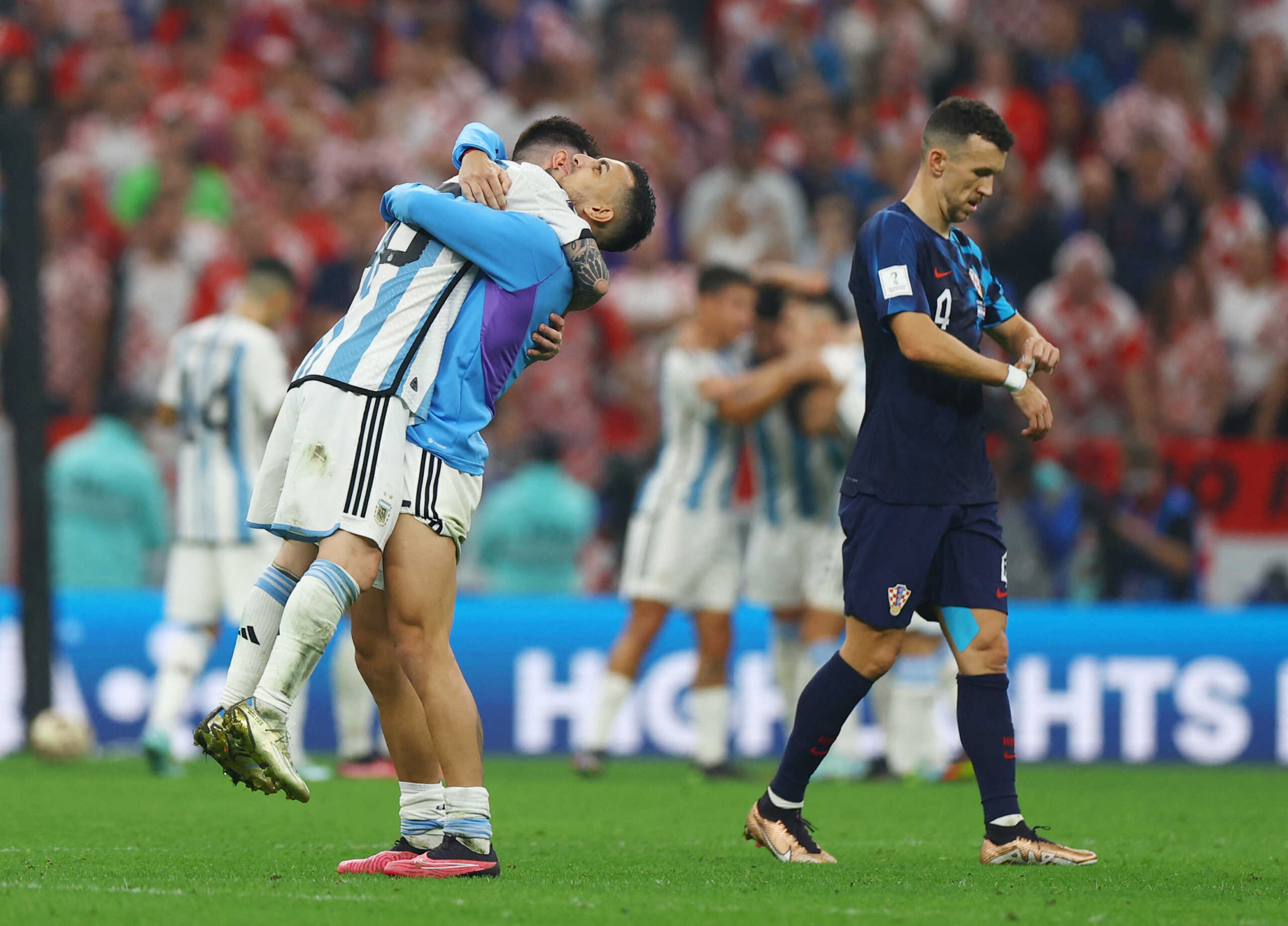 Soccer Football - FIFA World Cup Qatar 2022 - Semi Final - Argentina v Croatia - Lusail Stadium, Lusail, Qatar - December 13, 2022 Argentina's Lionel Messi celebrates with Leandro Paredes after the match as Argentina progress to the final as Croatia's Ivan Perisic looks dejected after the match as Croatia are eliminated from the World Cup REUTERS