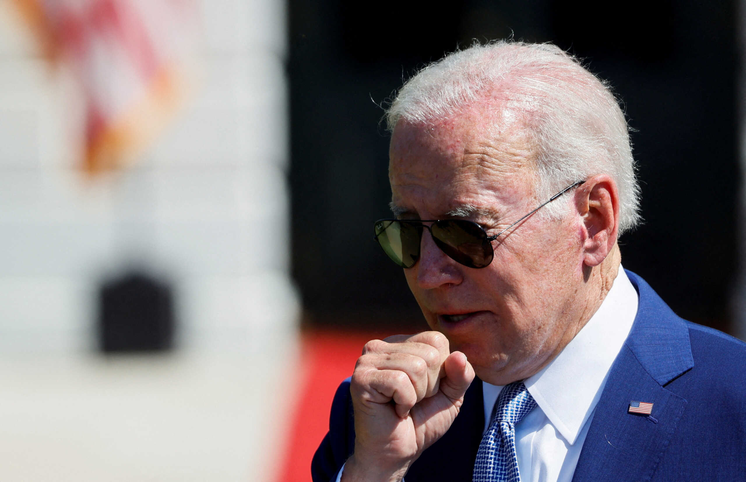 FILE PHOTO: U.S. President Joe Biden coughs during a signing event for the CHIPS and Science Act of 2022, on the South Lawn of the White House in Washington, U.S., August 9, 2022. REUTERS