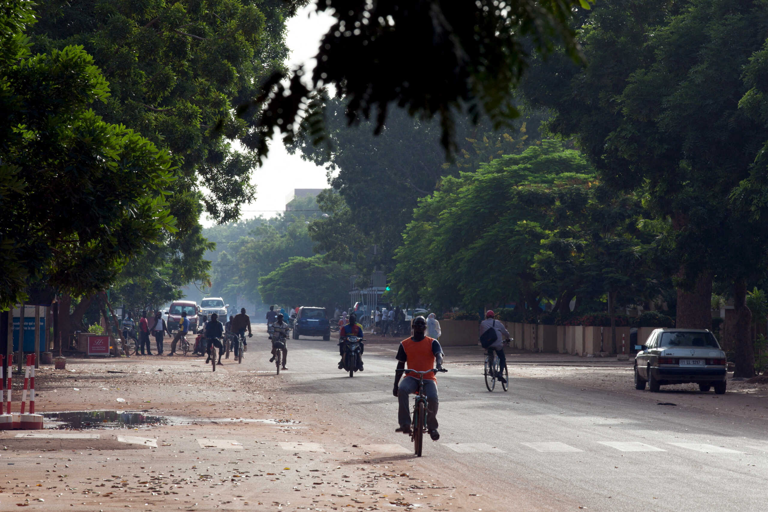 FILE PHOTO: People ride bicycles and motorcycles on a street in Ouagadougou, Burkina Faso, September 17, 2015. REUTERS