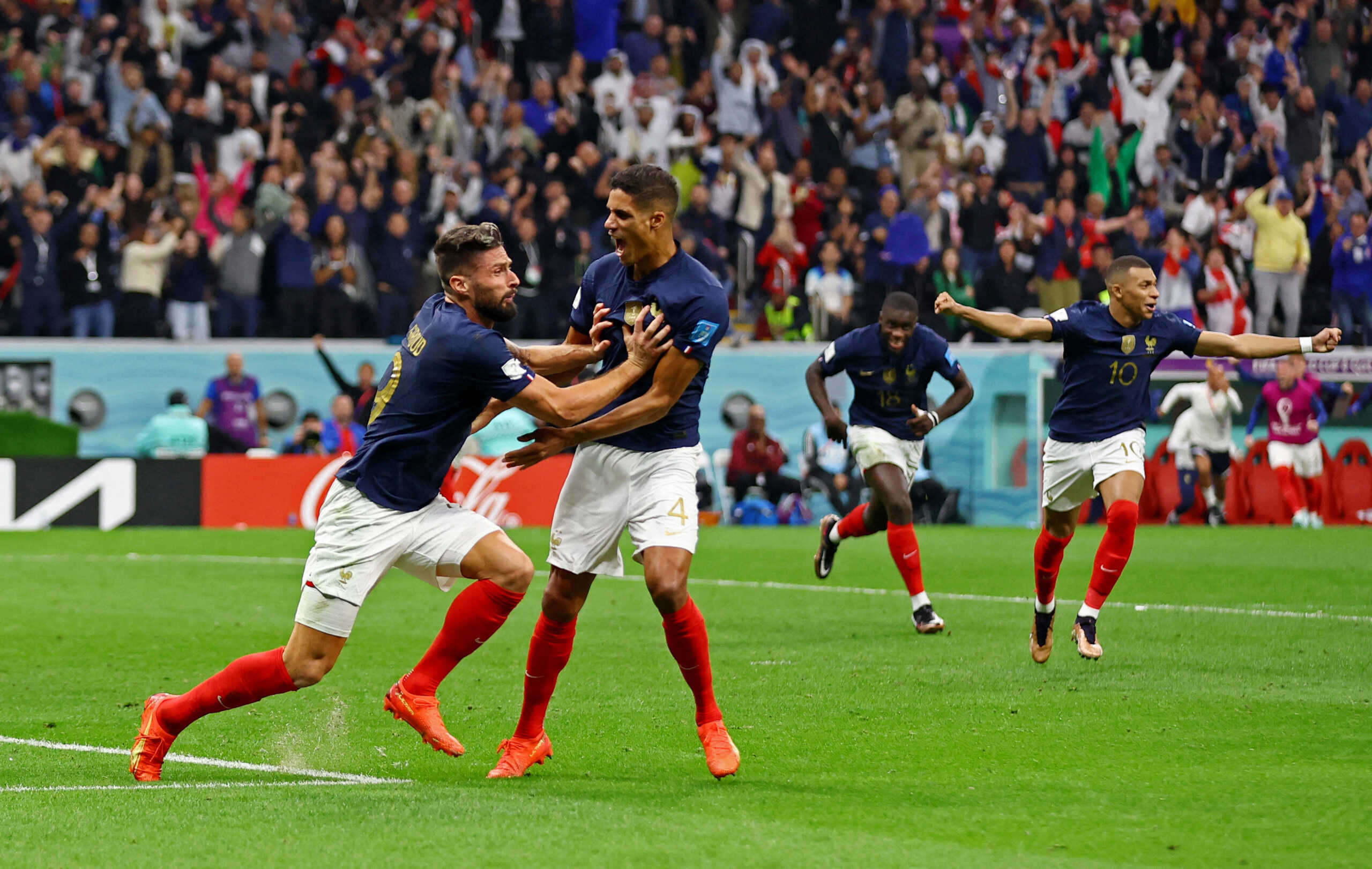 Soccer Football - FIFA World Cup Qatar 2022 - Quarter Final - England v France - Al Bayt Stadium, Al Khor, Qatar - December 10, 2022 France's Olivier Giroud celebrates scoring their second goal with Raphael Varane, Kylian Mbappe and Dayot Upamecano REUTERS