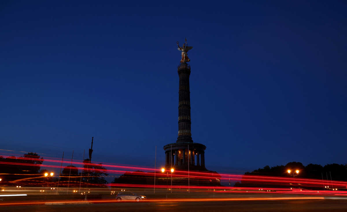 FILE PHOTO: Cars make their way past the Victory Column shows a reduced lighting to save energy due to Russia's invasion of Ukraine in Berlin, Germany August 6, 2022. REUTERS