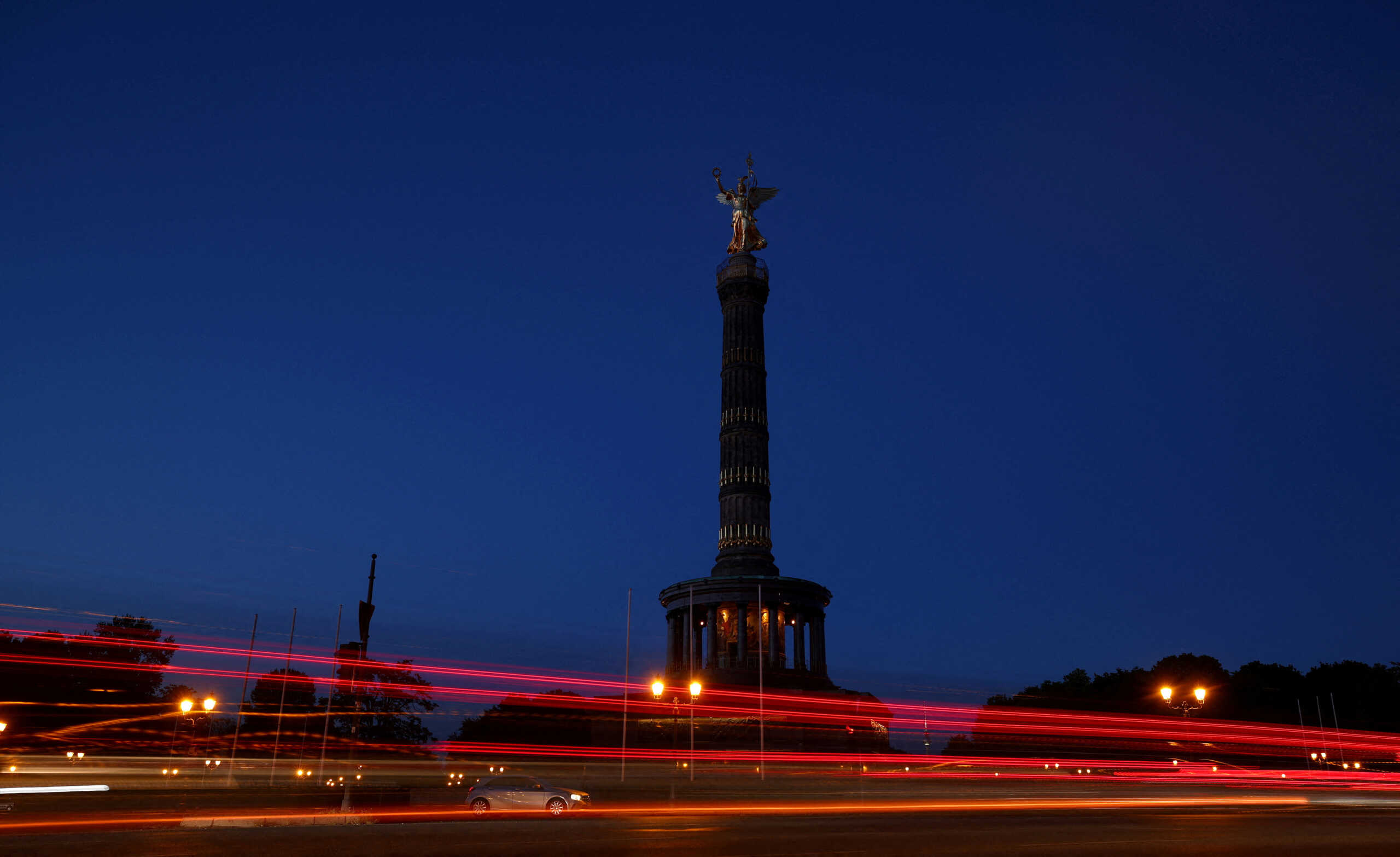 FILE PHOTO: Cars make their way past the Victory Column shows a reduced lighting to save energy due to Russia's invasion of Ukraine in Berlin, Germany August 6, 2022. REUTERS