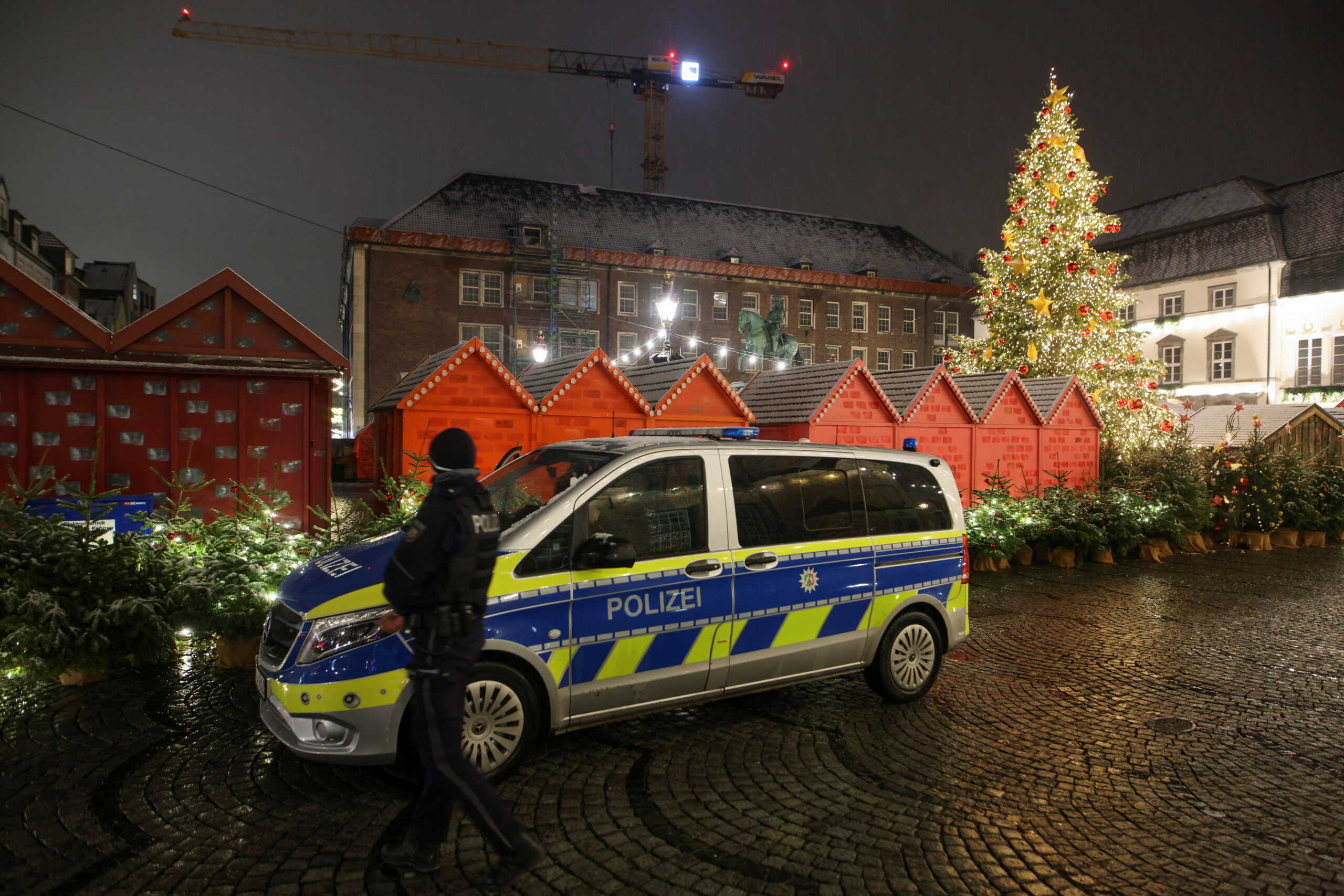 A police vehicle is seen next to closed stalls at a Christmas market after the city of Duesseldorf cleared the city centre and Christmas Markets in Dusseldorf, Germany, December 5, 2022. REUTERS
