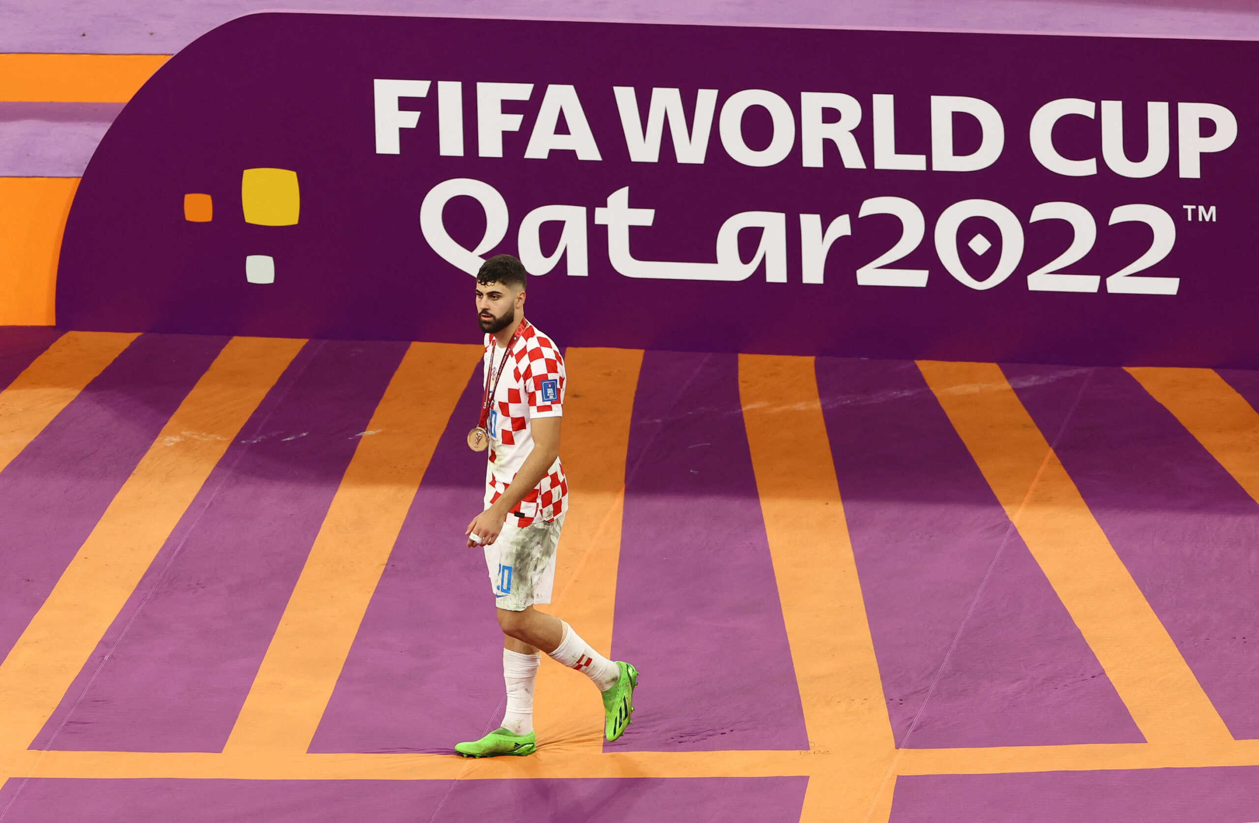 Soccer Football - FIFA World Cup Qatar 2022 - Third-Place Playoff - Croatia v Morocco - Khalifa International Stadium, Doha, Qatar - December 17, 2022 Croatia's Josko Gvardiol celebrates with his medal on stage as Croatia finish in third place REUTERS