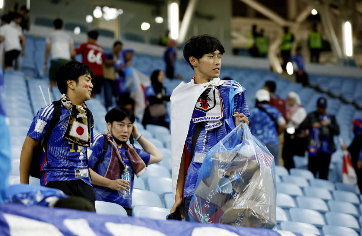 Soccer Football - FIFA World Cup Qatar 2022 - Round of 16 - Japan v Croatia - Al Janoub Stadium, Al Wakrah, Qatar - December 5, 2022  Japan fans clean up after the penalty shootout as Japan are eliminated from the World Cup REUTERS