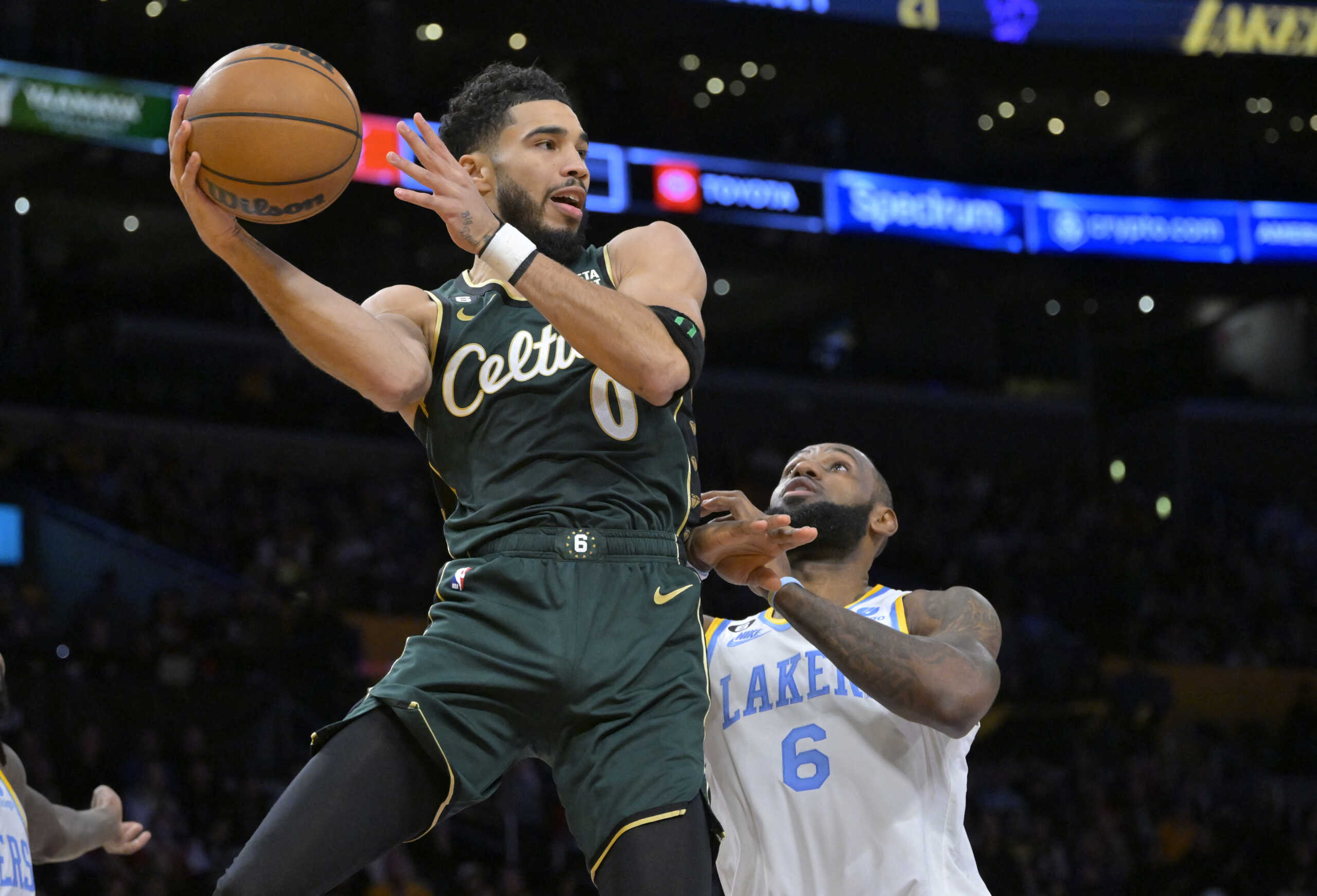 Dec 13, 2022; Los Angeles, California, USA;  Boston Celtics forward Jayson Tatum (0) is defended by Los Angeles Lakers forward LeBron James (6) as he makes a pass in the first half at Crypto.com Arena. Mandatory Credit: Jayne Kamin-Oncea-USA TODAY Sports