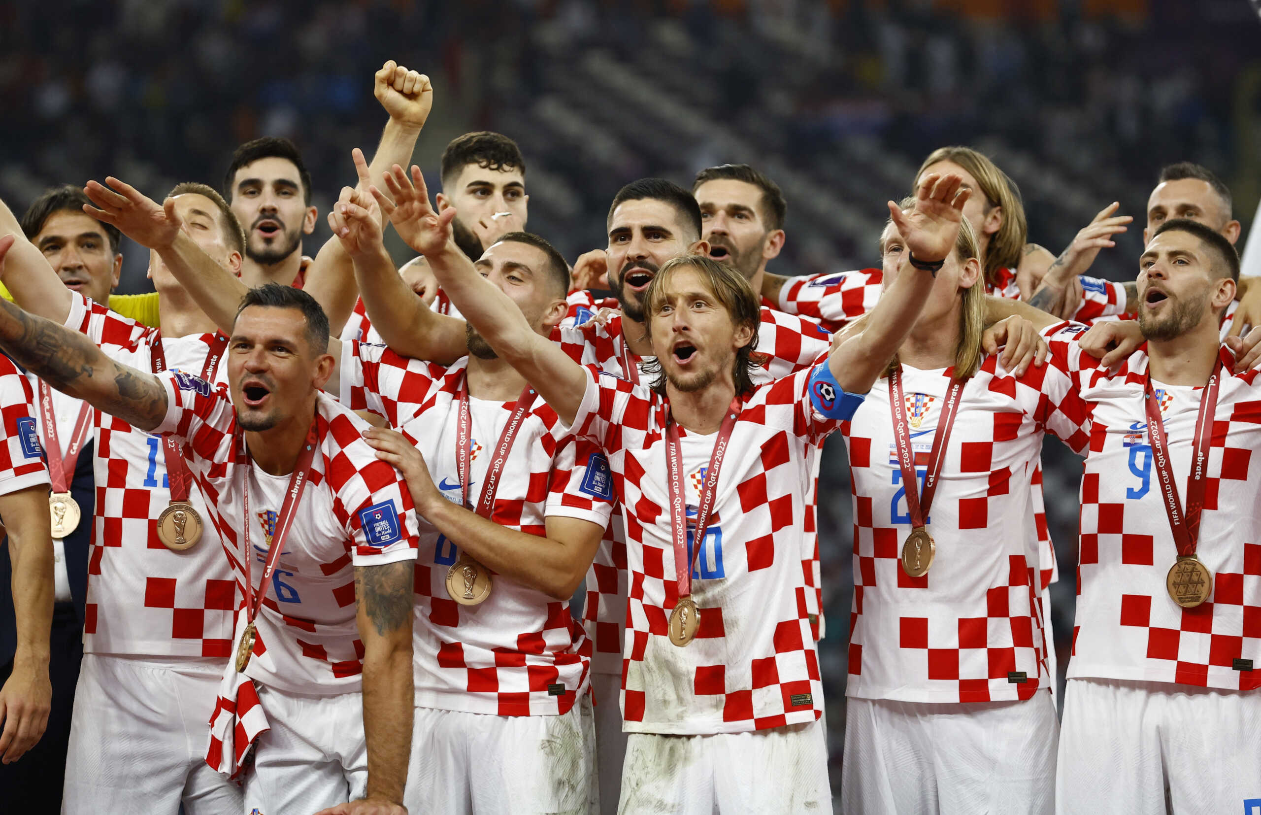Soccer Football - FIFA World Cup Qatar 2022 - Third-Place Playoff - Croatia v Morocco - Khalifa International Stadium, Doha, Qatar - December 17, 2022 Croatia's Luka Modric and teammates celebrate with their medals on stage as they finish in third place REUTERS