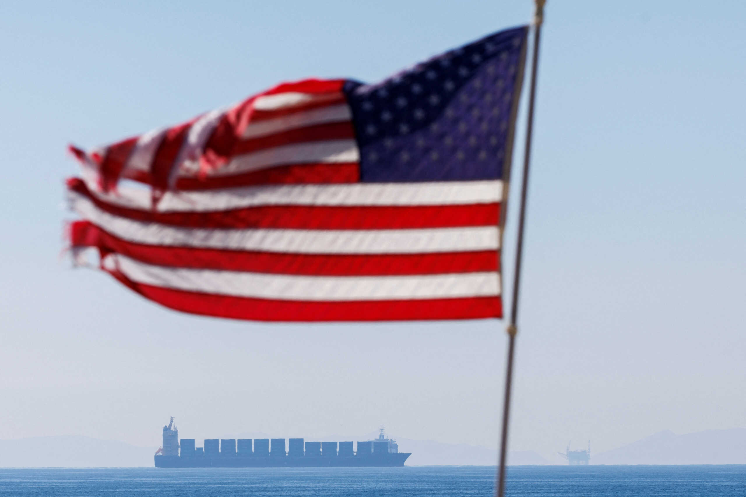 FILE PHOTO: A cargo ship sits off the coast of Huntington Beach waiting for access to the Ports of Los Angeles and Long Beach in Huntington Beach, California, U.S., January 3, 2022. REUTERS